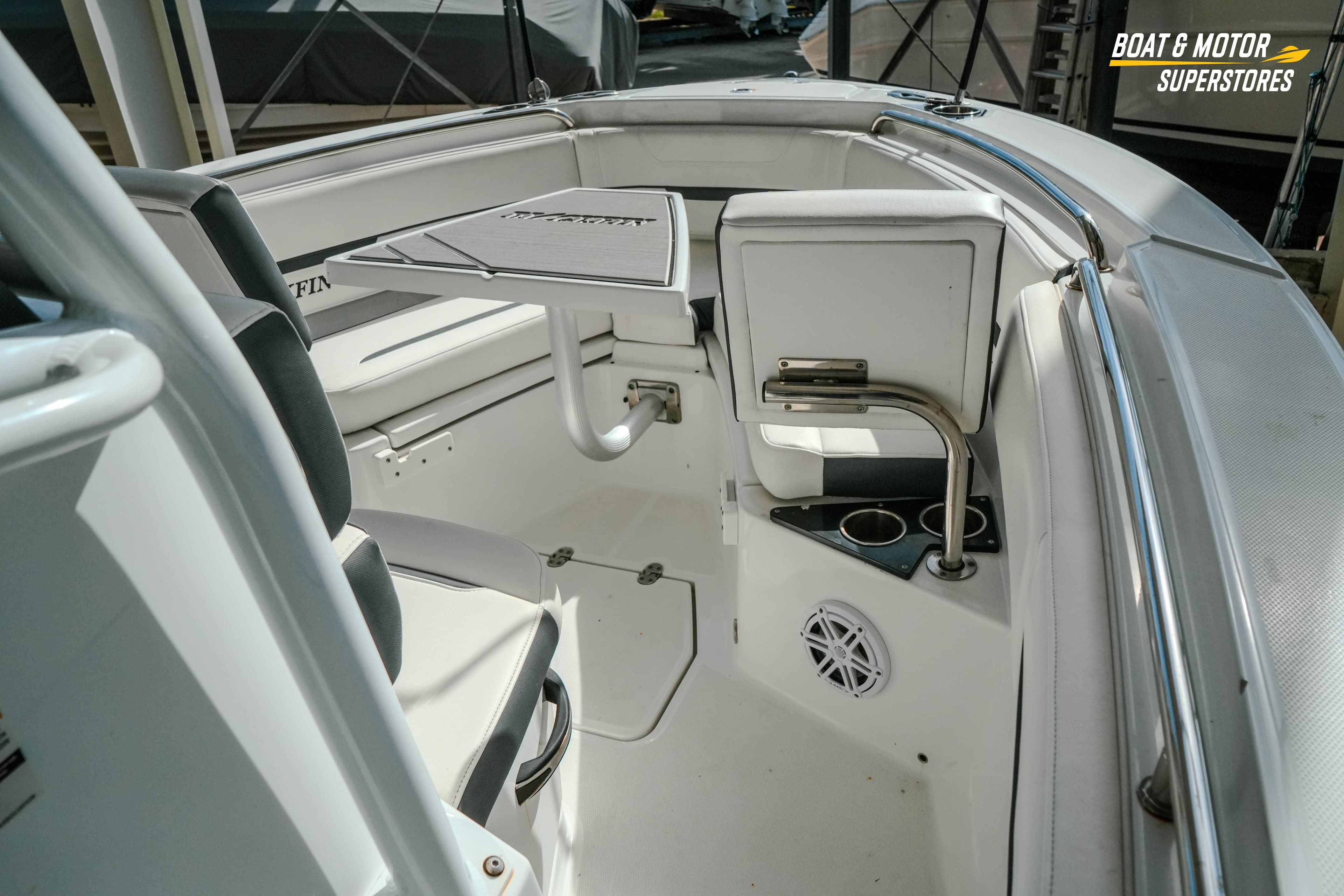 2022 Blackfin 222 CC boat interior with seating, table, and cup holders.
