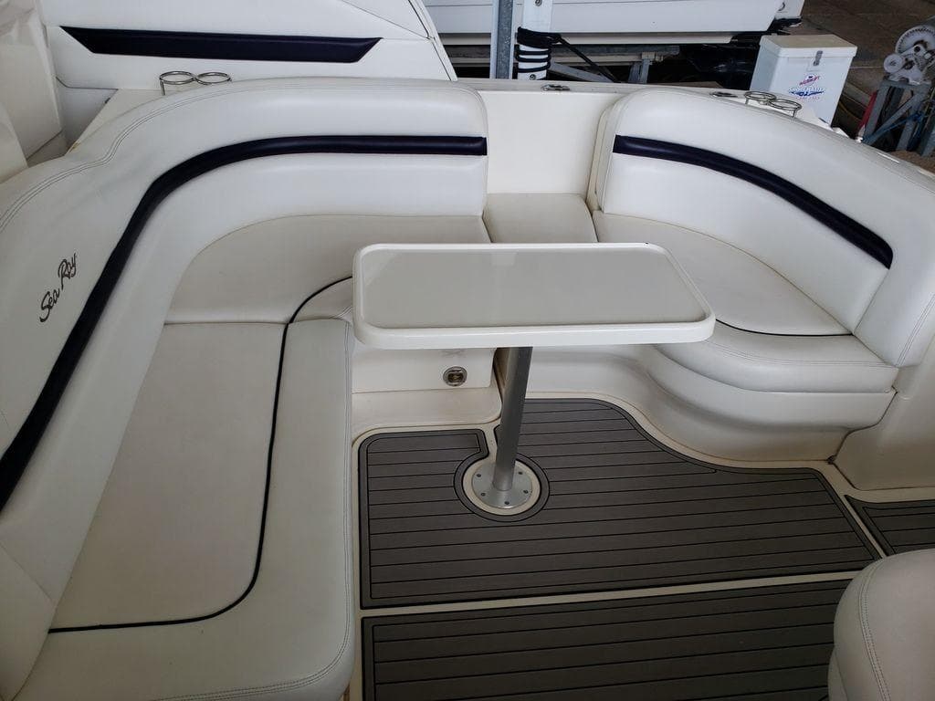 2008 Sea Ray 38 Sundancer boat interior with white seating and table.