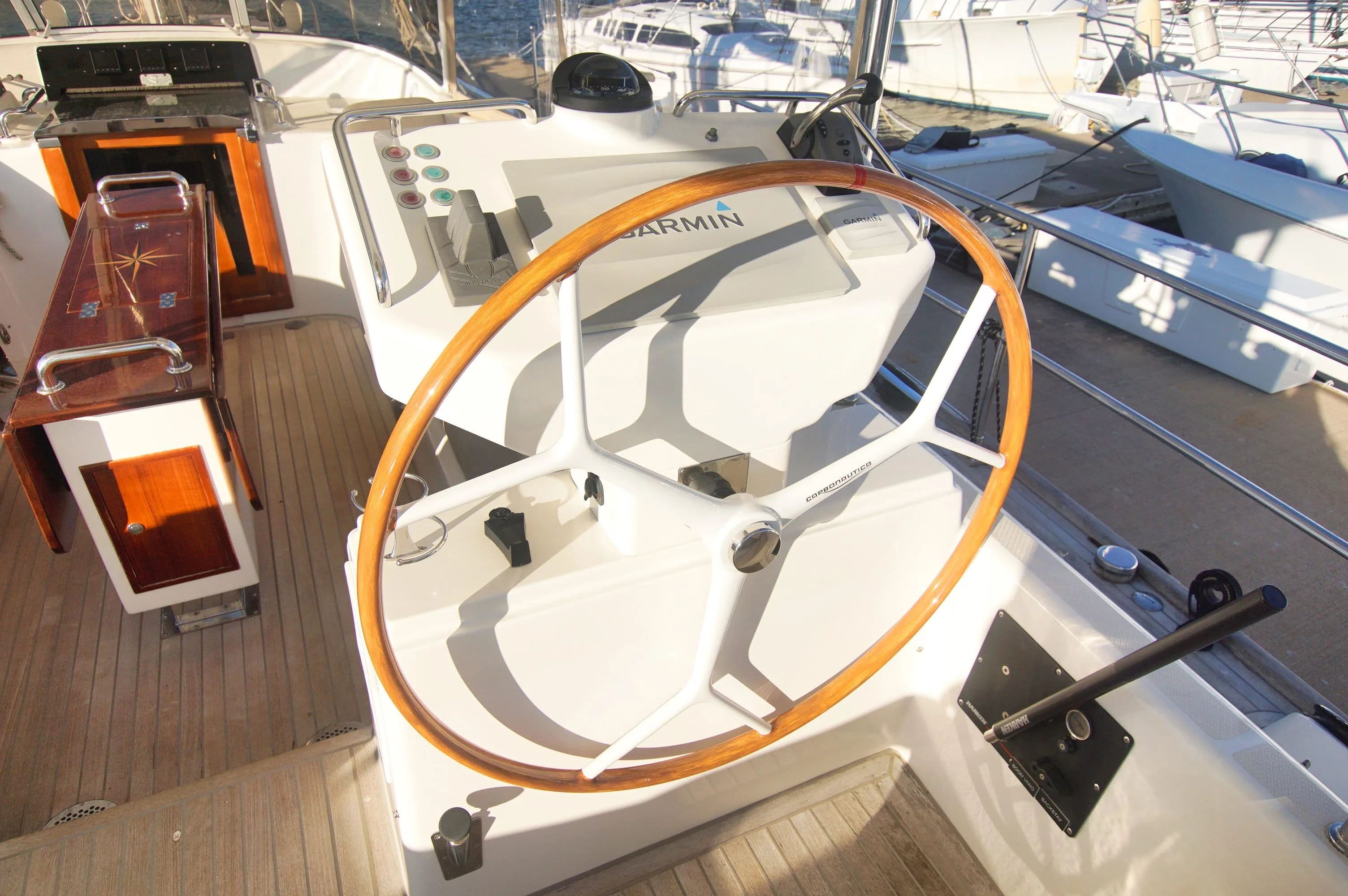 Cockpit of a 2015 Hylas 70 yacht with wooden steering wheel.