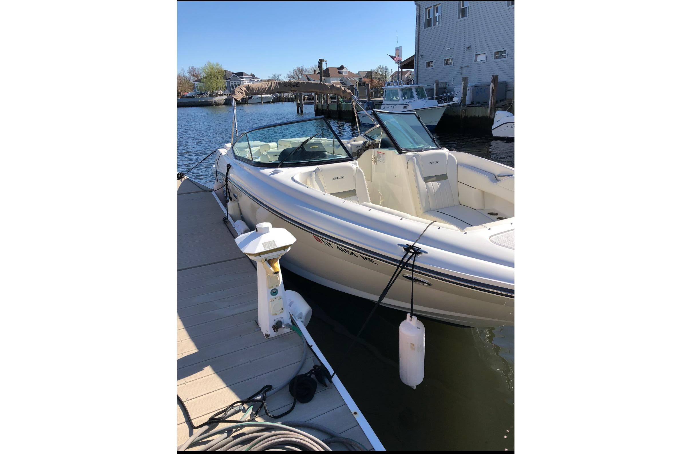 2007 Sea Ray 270 SLX boat docked at marina, sunny day, calm water.