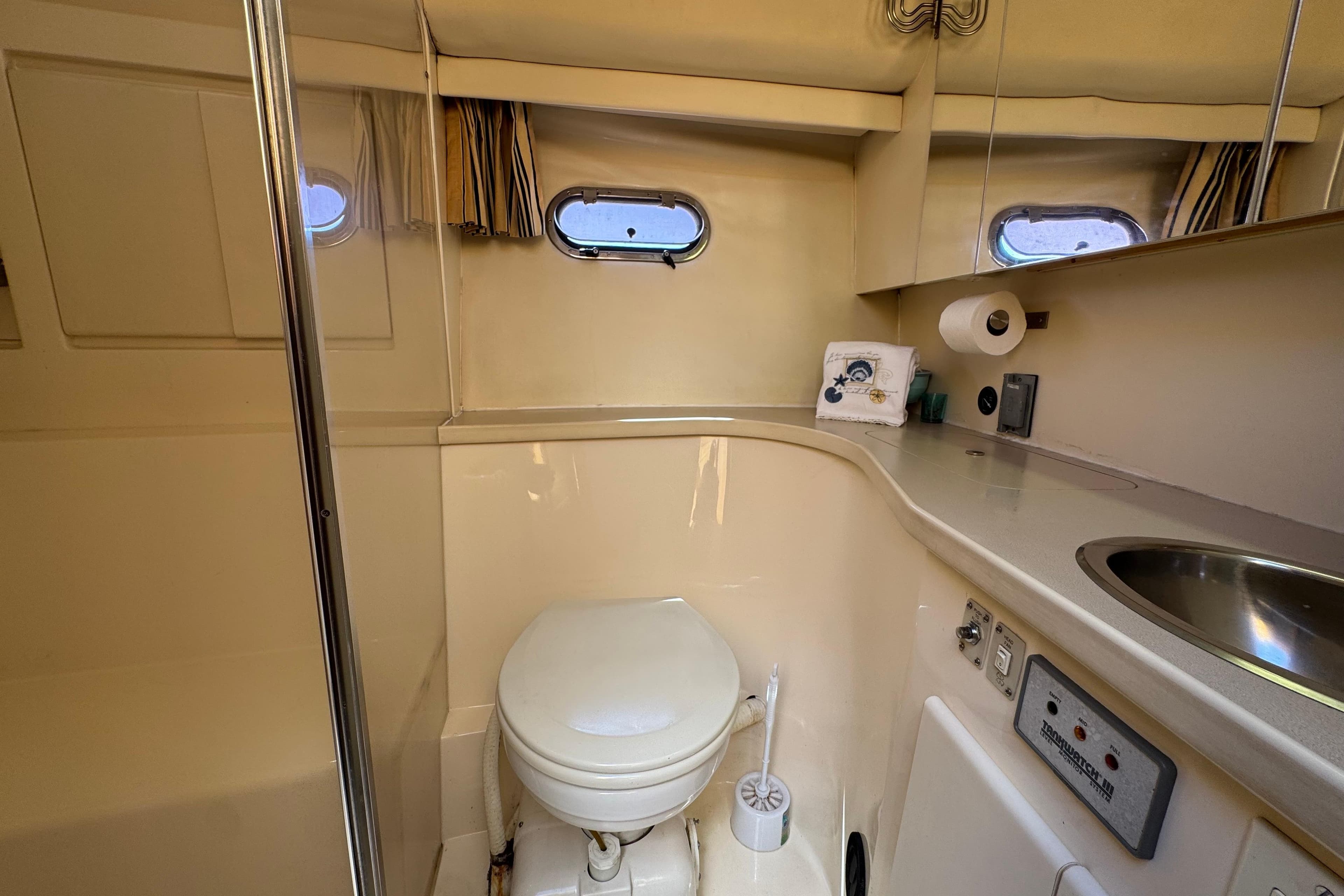 Bathroom interior of a 1996 Carver 370 Voyager yacht, featuring a toilet and sink.