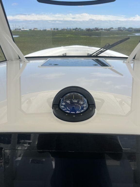 2021 Regulator 41 boat dashboard with compass, clear sky in background.