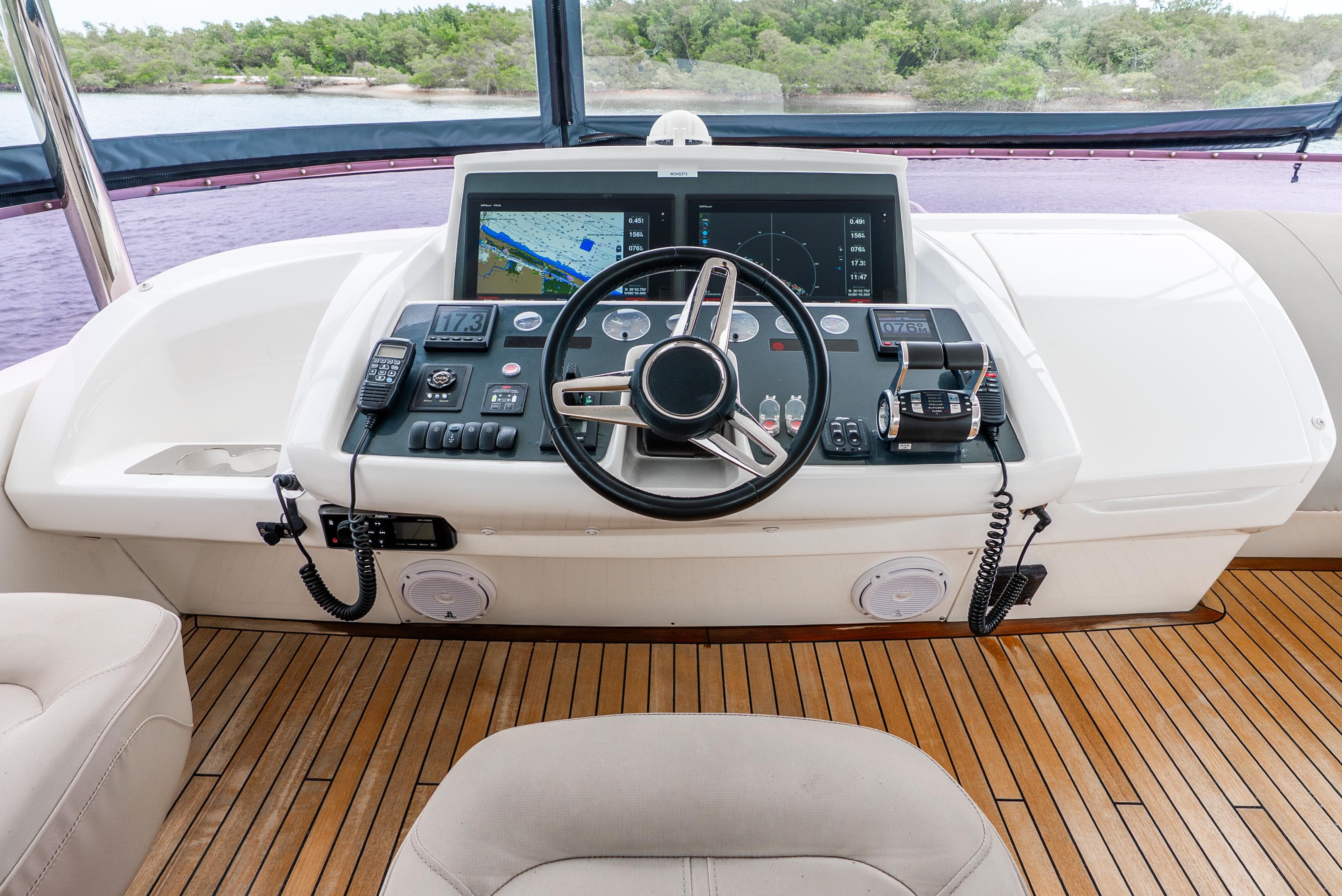 Helm of 2018 Princess F-68 yacht with navigation controls and wooden deck.