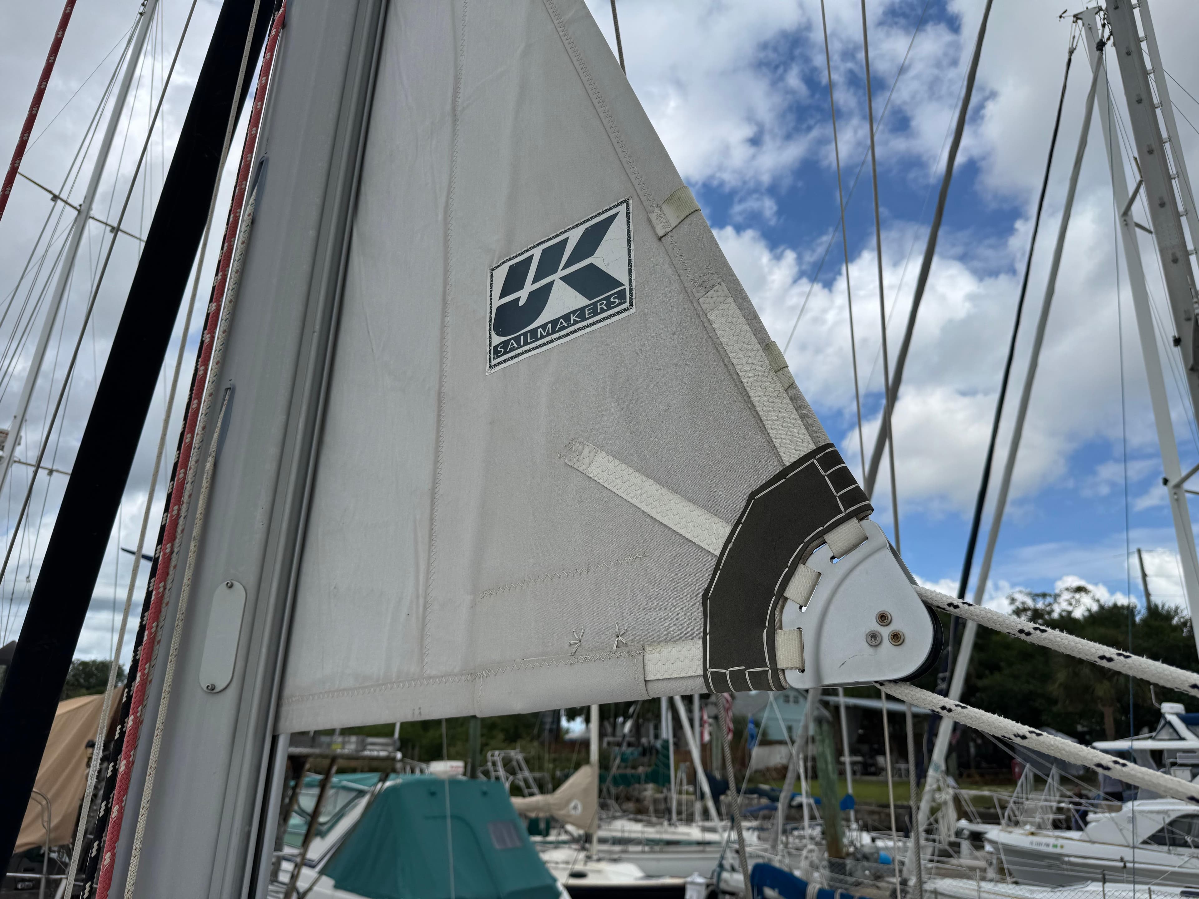 Close-up of a sail on a 1997 Beneteau Oceanis 461, featuring UK Sailmakers logo.