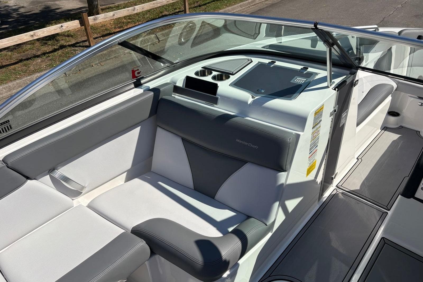 2019 MasterCraft boat interior with gray and white seating, cup holders, and dashboard.