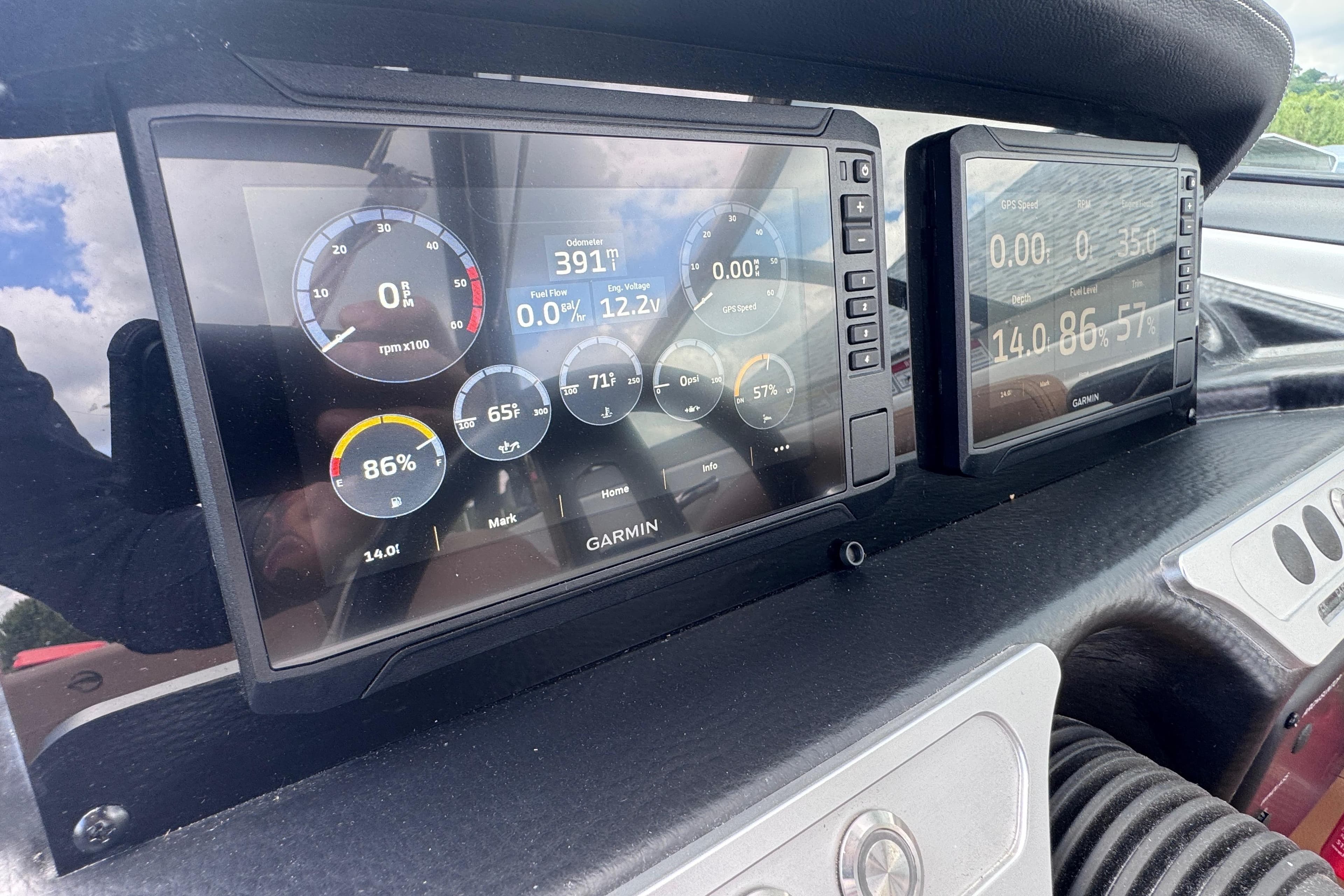 Dashboard of 2025 Crownline Eclipse E235 boat with Garmin displays showing engine metrics.