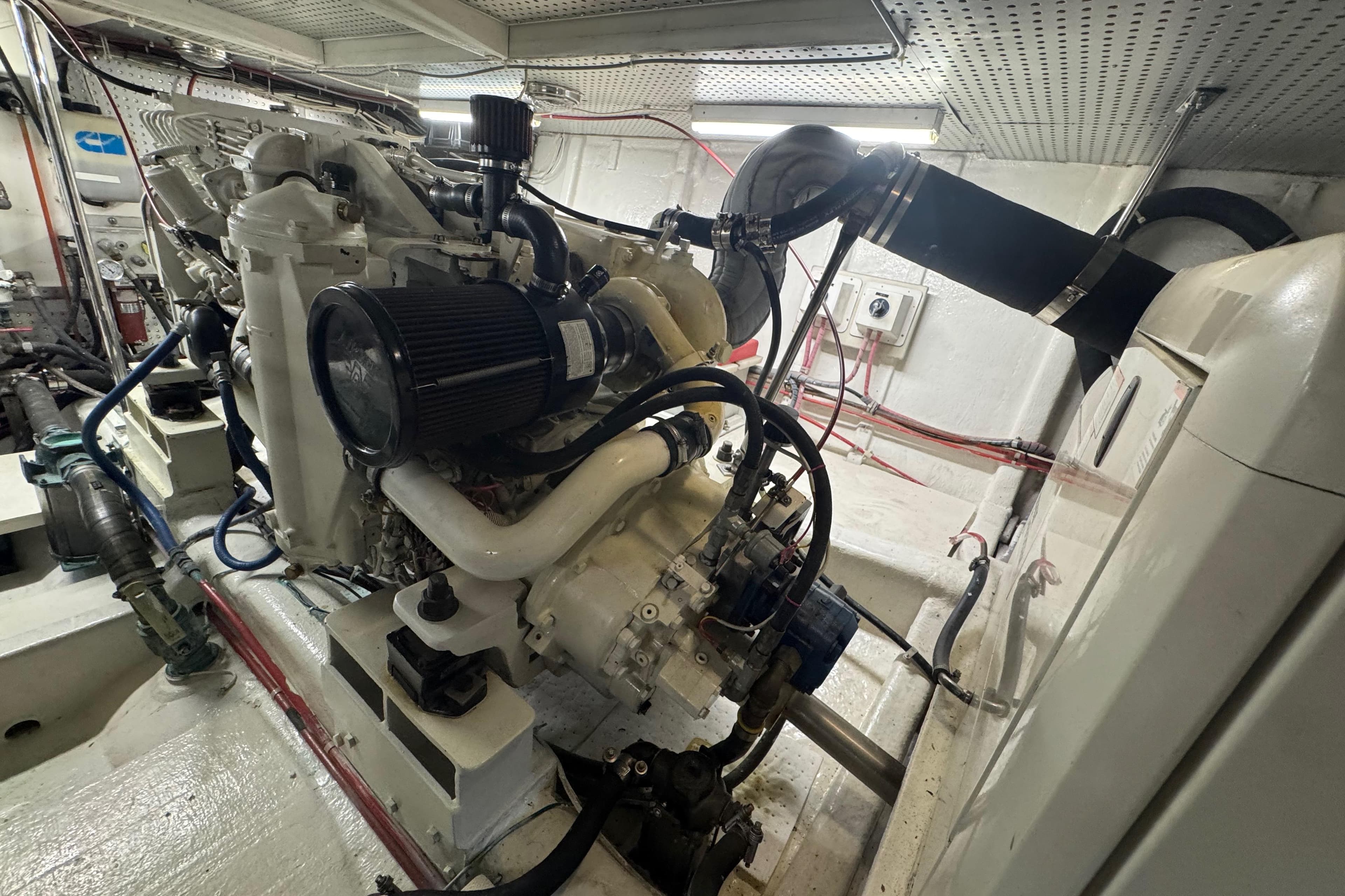 Engine room of a 2002 Hampton 550 yacht, showcasing detailed machinery and components.