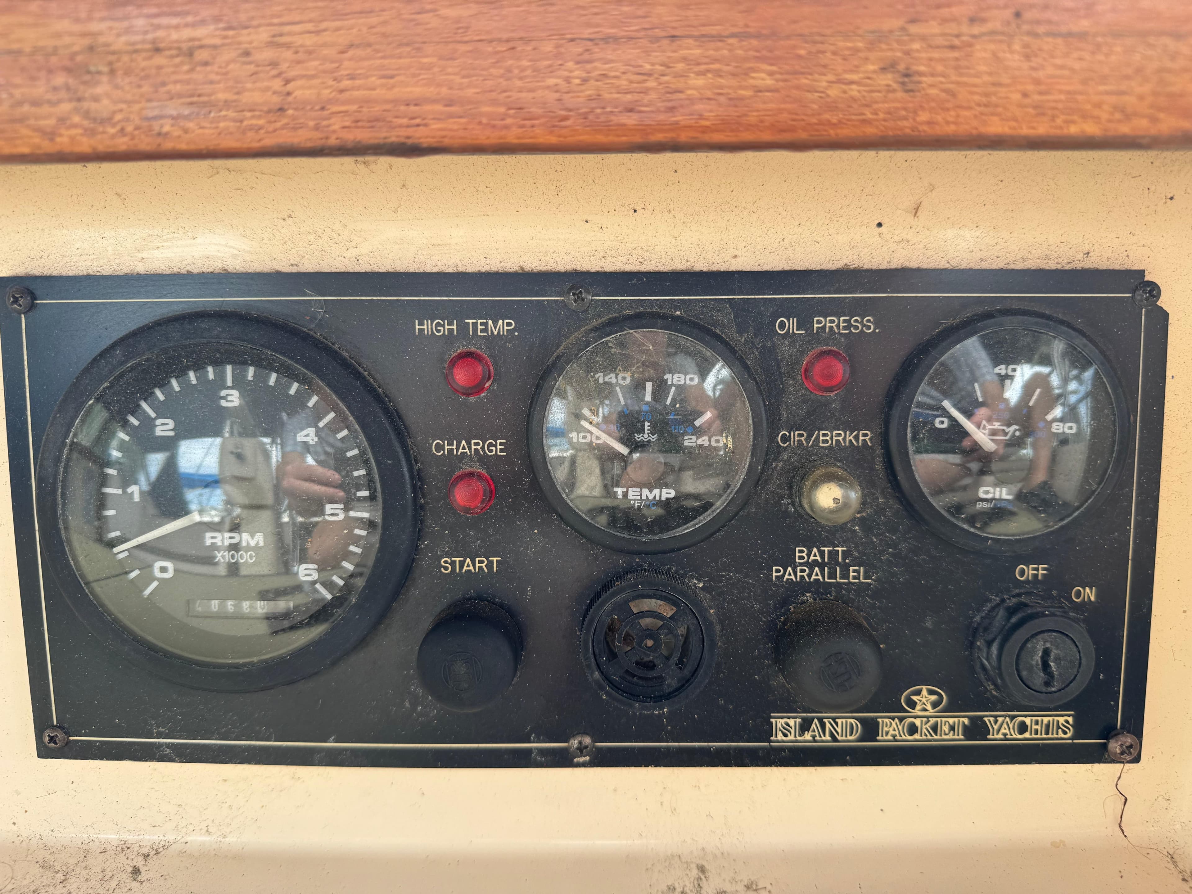 Control panel of a 2002 Island Packet 380 yacht with RPM, temperature, and oil pressure gauges.