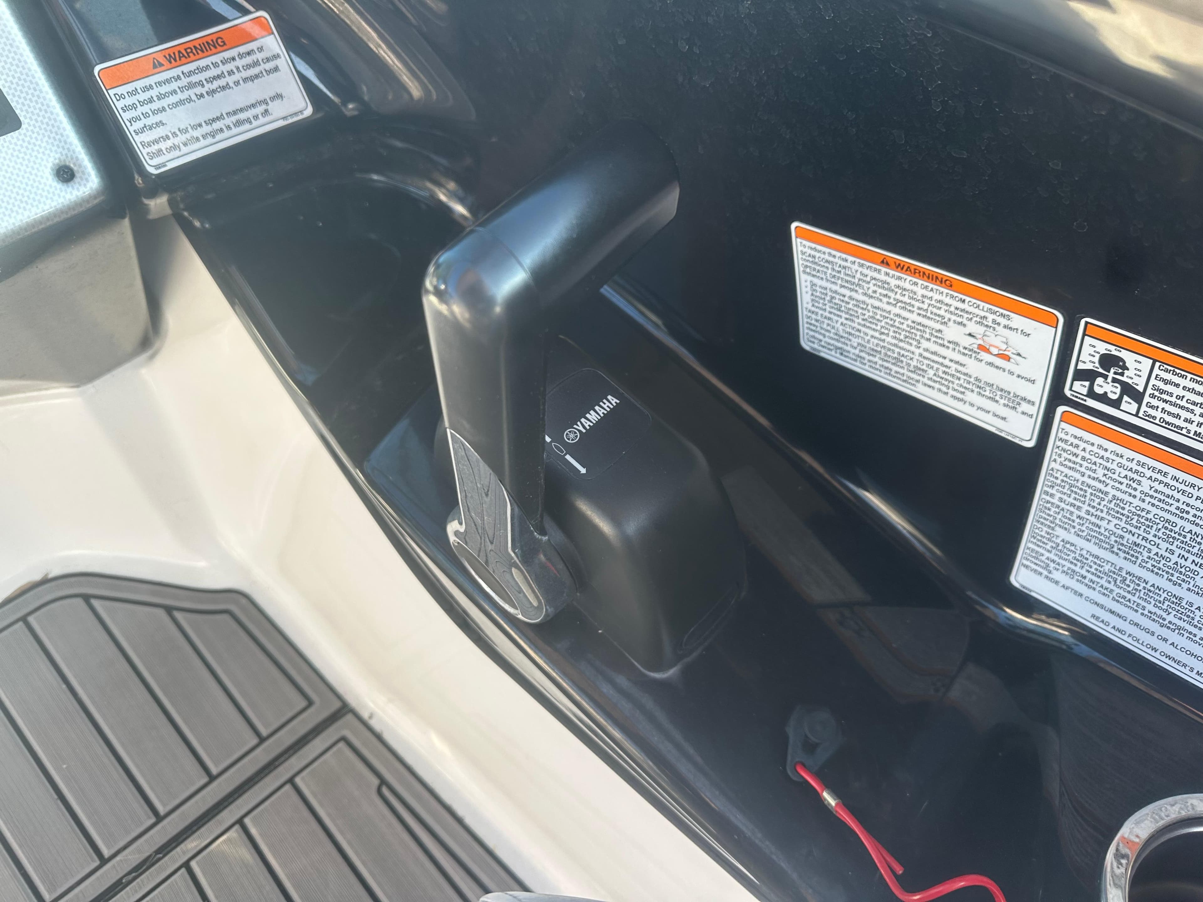 Close-up of 2013 Yamaha SX192 boat throttle control with safety warnings.