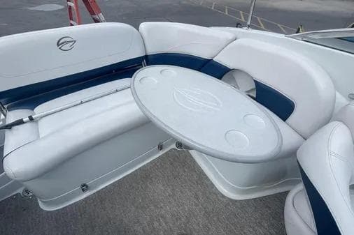 2012 Crownline Eclipse E2 boat interior with white seating and a round table.
