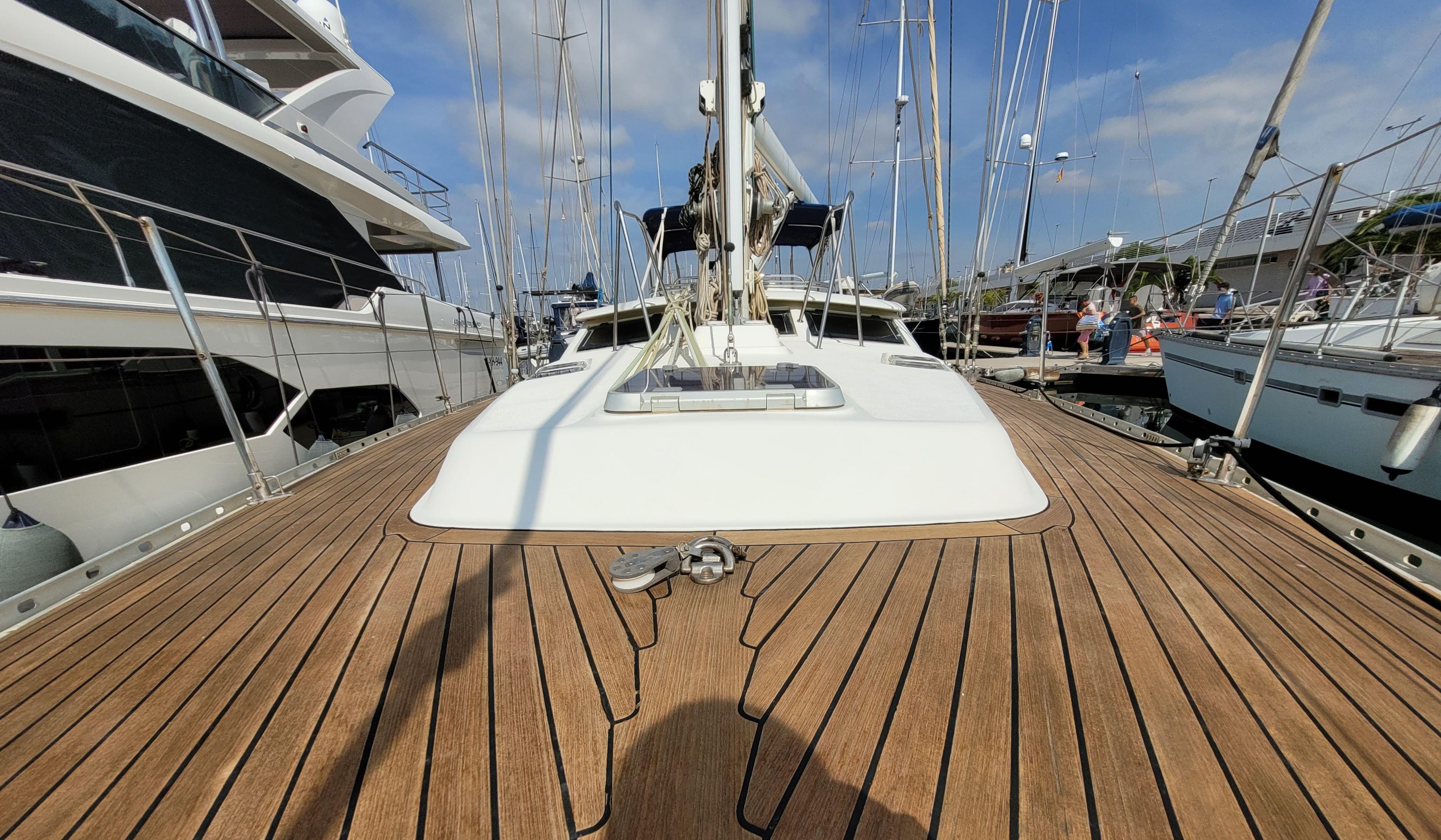 Deck view of a 1996 Oyster 45 sailboat docked at a marina.