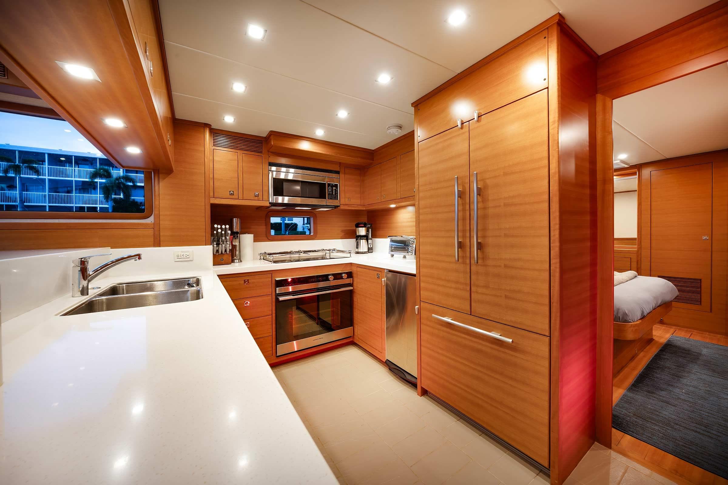 Luxurious kitchen interior of 2025 Nordhavn 625 yacht with modern appliances and wood finish.