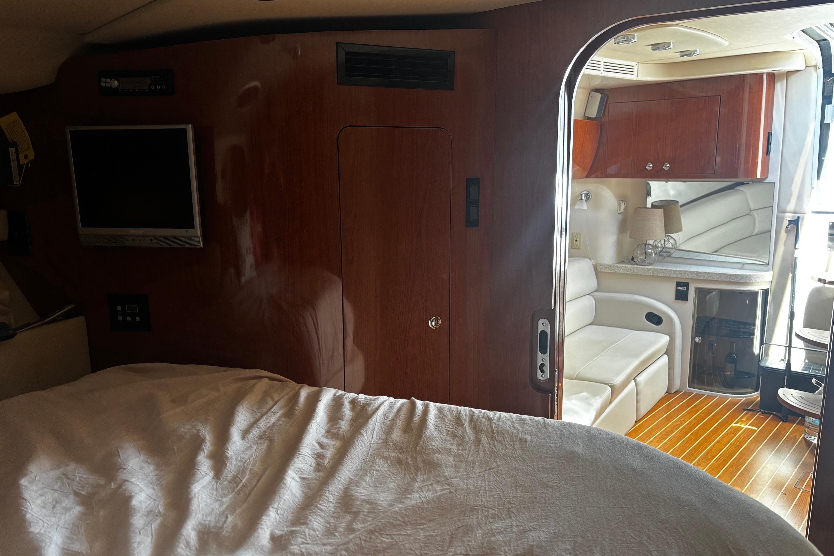 Interior of 2006 Regal Commodore 3860 yacht with wood paneling and cozy seating area.