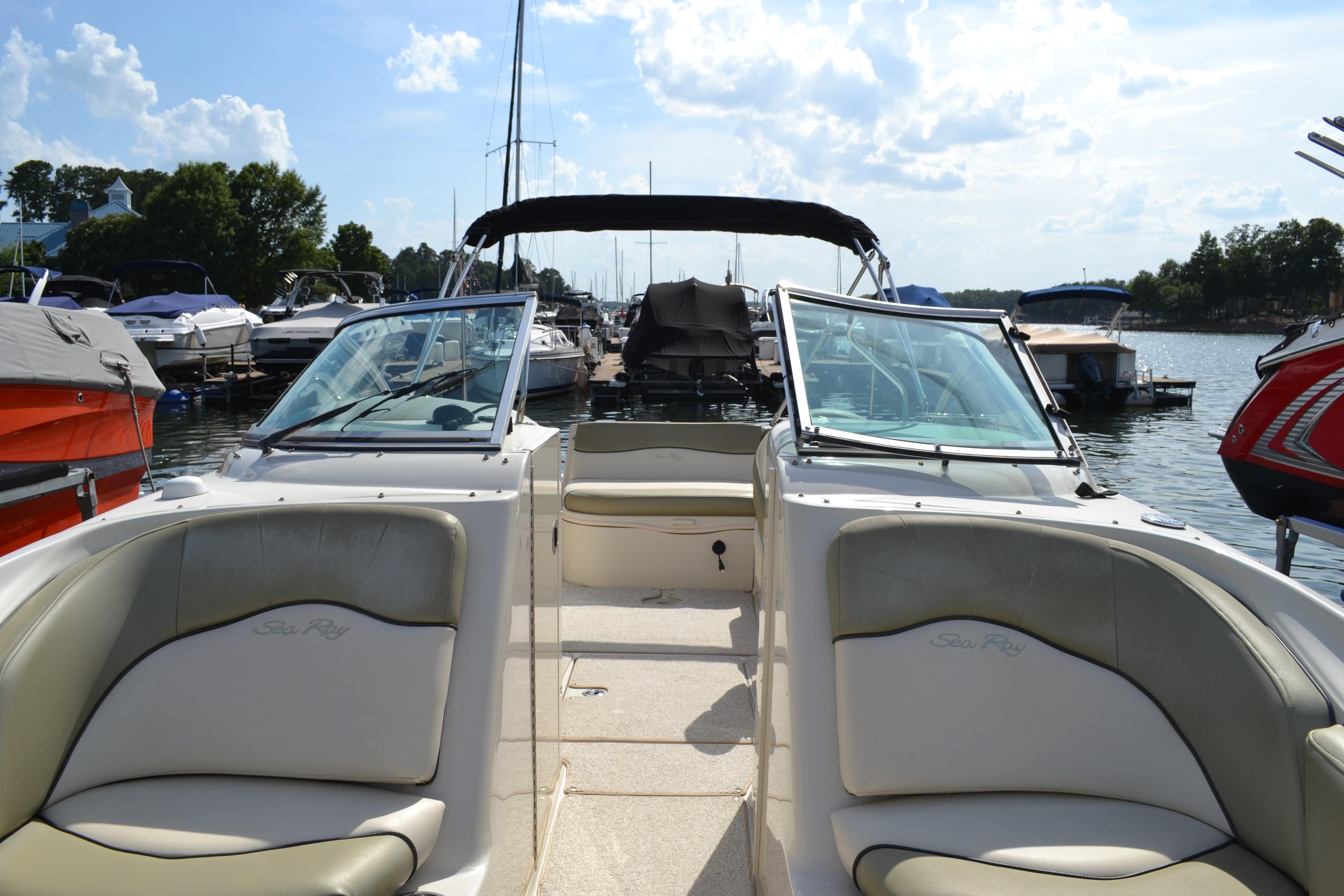 2005 Sea Ray 240 Sundeck boat interior with open bow seating at a marina.
