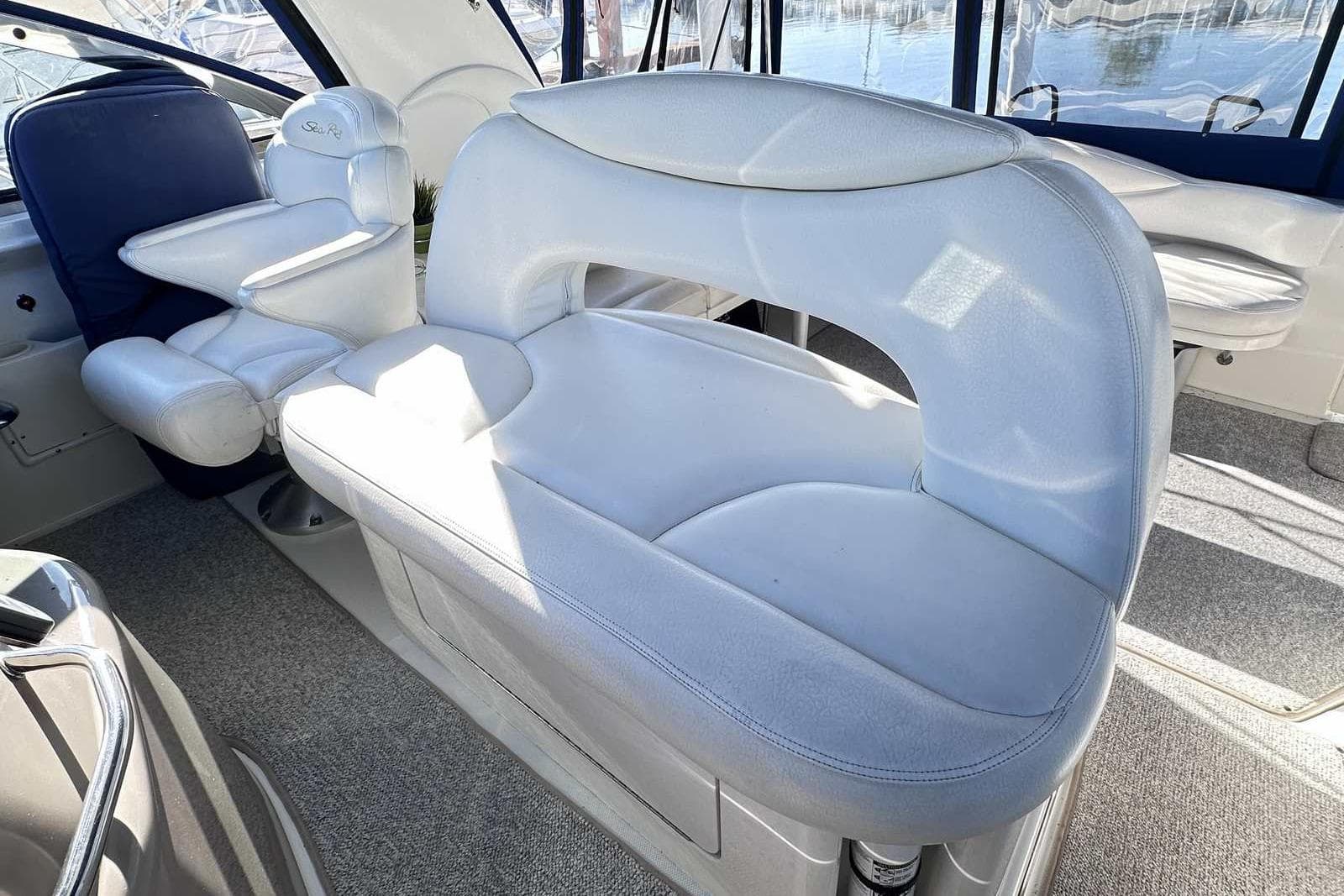 Interior seating of 2000 Sea Ray 410 Sundancer yacht, featuring plush white upholstery.
