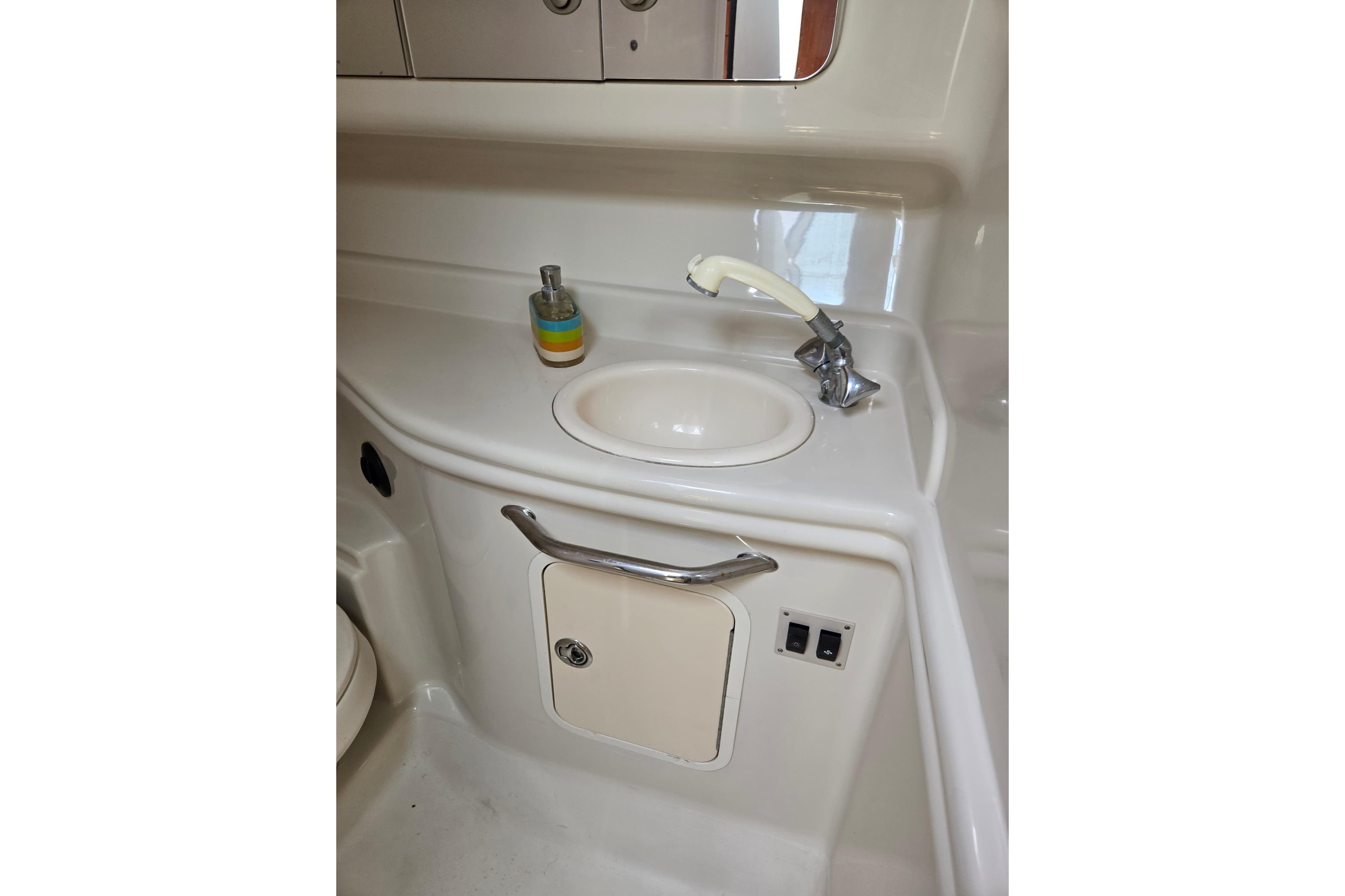 2006 Sea Ray Sundancer 320 bathroom sink with faucet and soap dispenser.