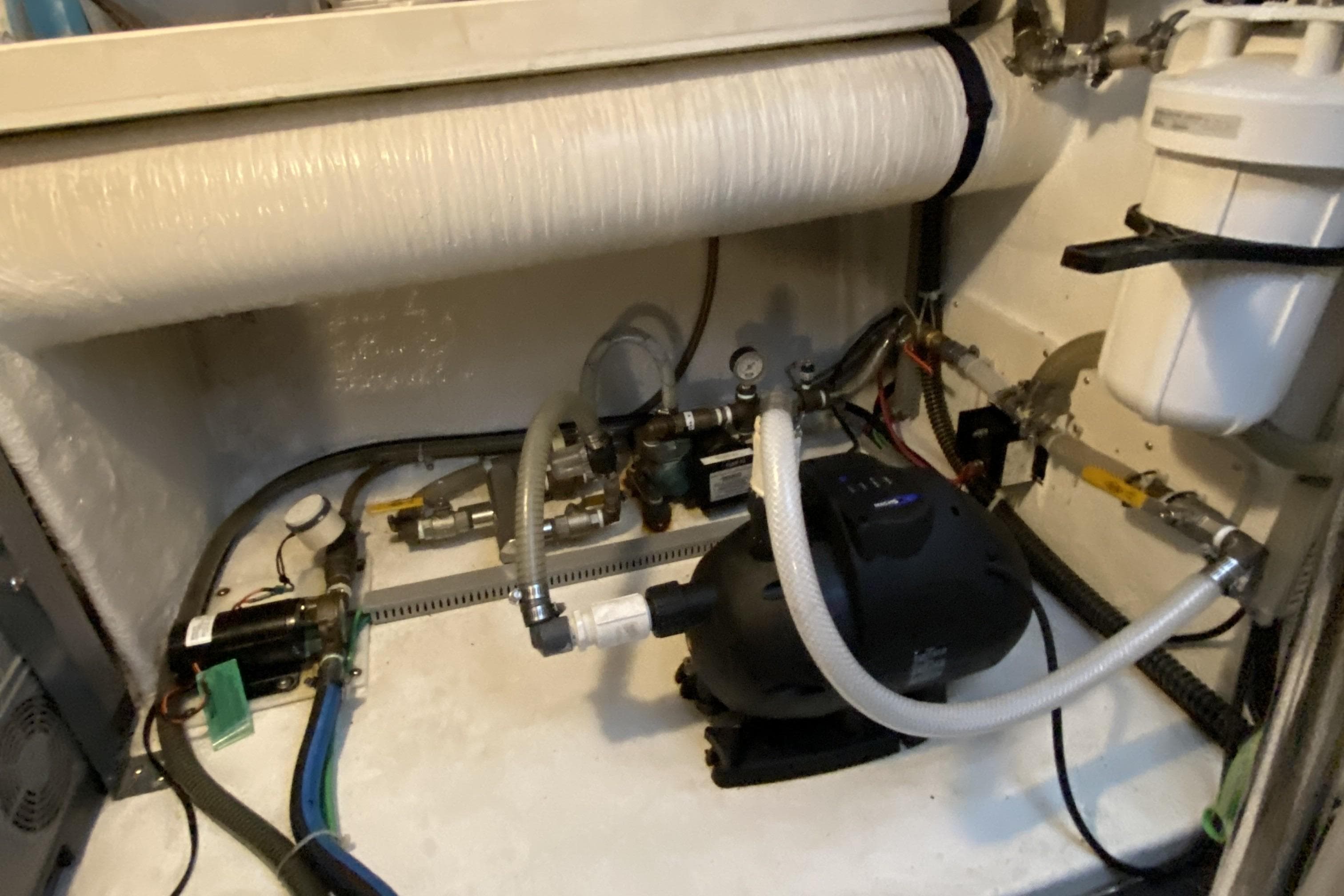 Engine room of a 2000 Compass 55 boat with various mechanical components.