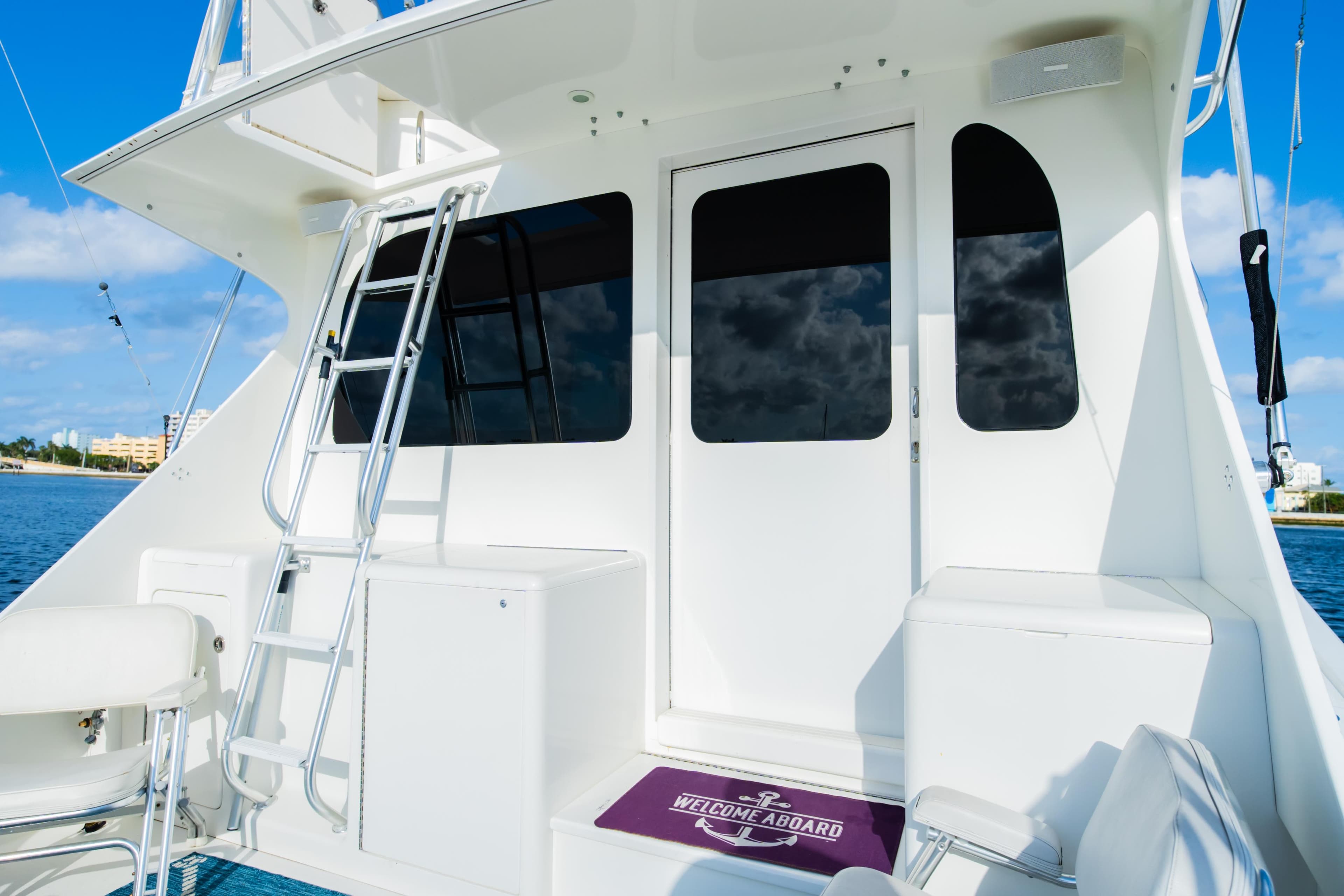 2008 Post 42 yacht deck with ladder and seating, under clear blue sky.