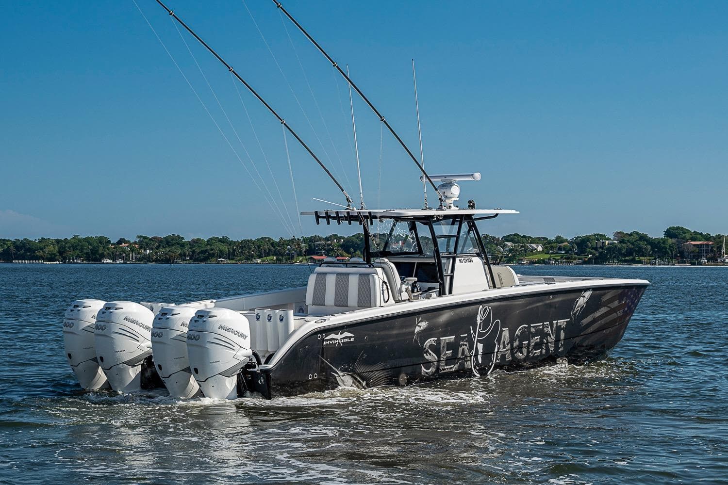 2018 Invincible 40 Catamaran with four engines cruising on a sunny day.