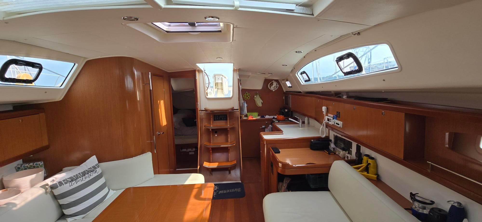 Interior of 2008 Beneteau Oceanis 40 sailboat with modern wood finish and cozy seating.