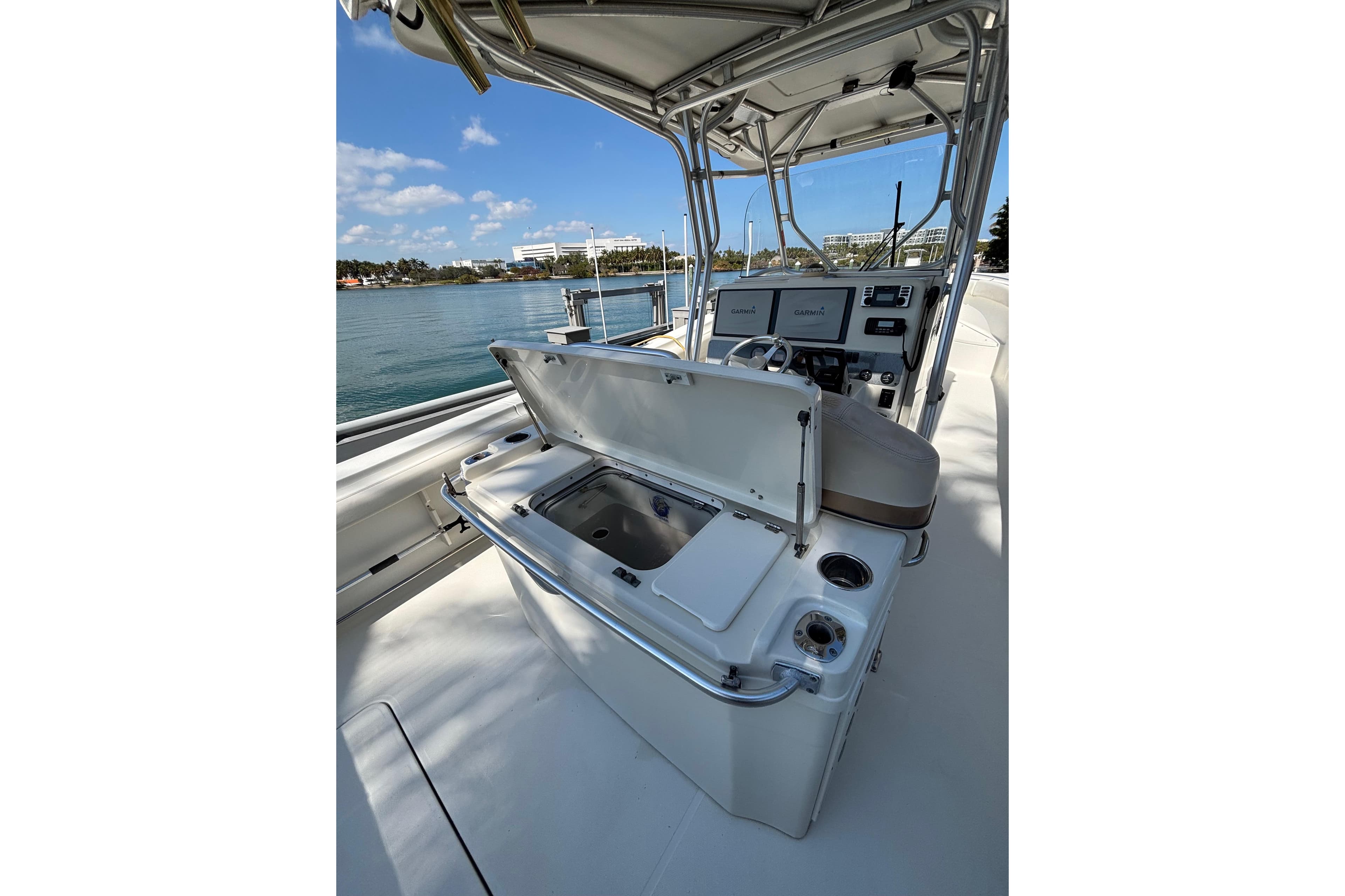 2006 Hydra-Sports Vector 3300 CC boat interior with open storage compartment, helm, and ocean view.