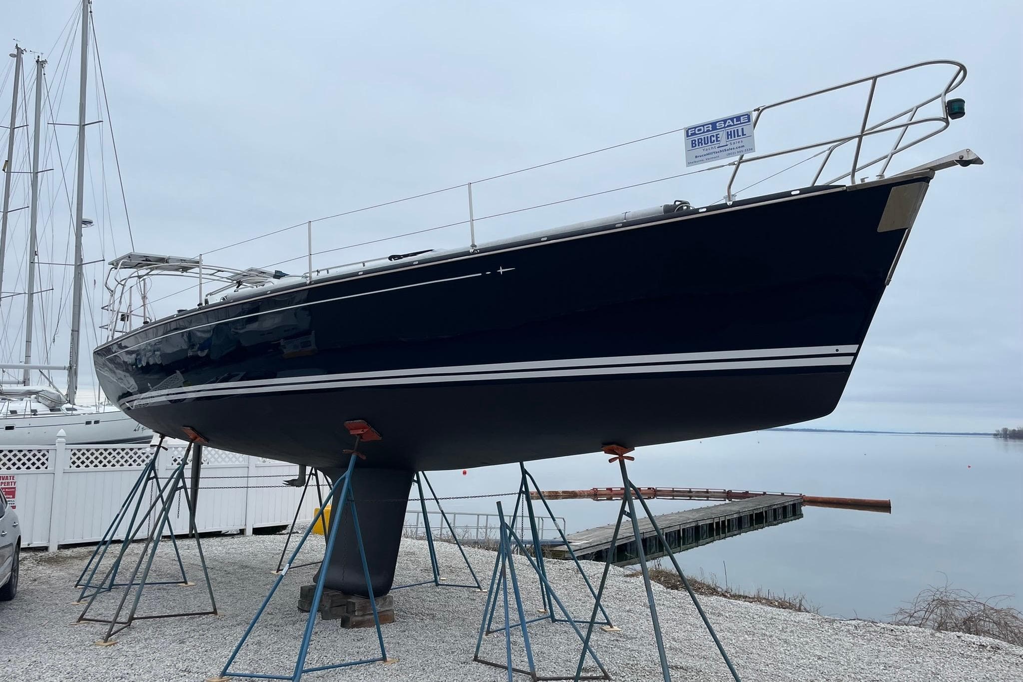2002 C&C 121 sailboat on stands, for sale by the water.
