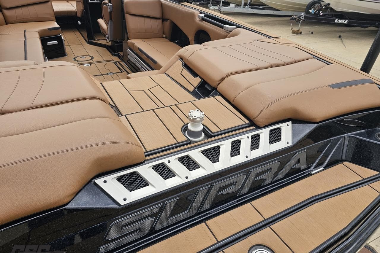 Luxurious interior of 2022 Supra SE 550 boat with tan seating and sleek design.