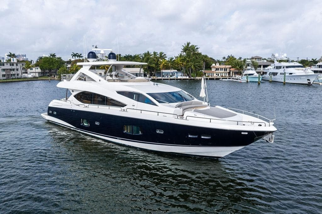 Luxurious 2012 Sunseeker 88 Yacht cruising on a scenic waterway.