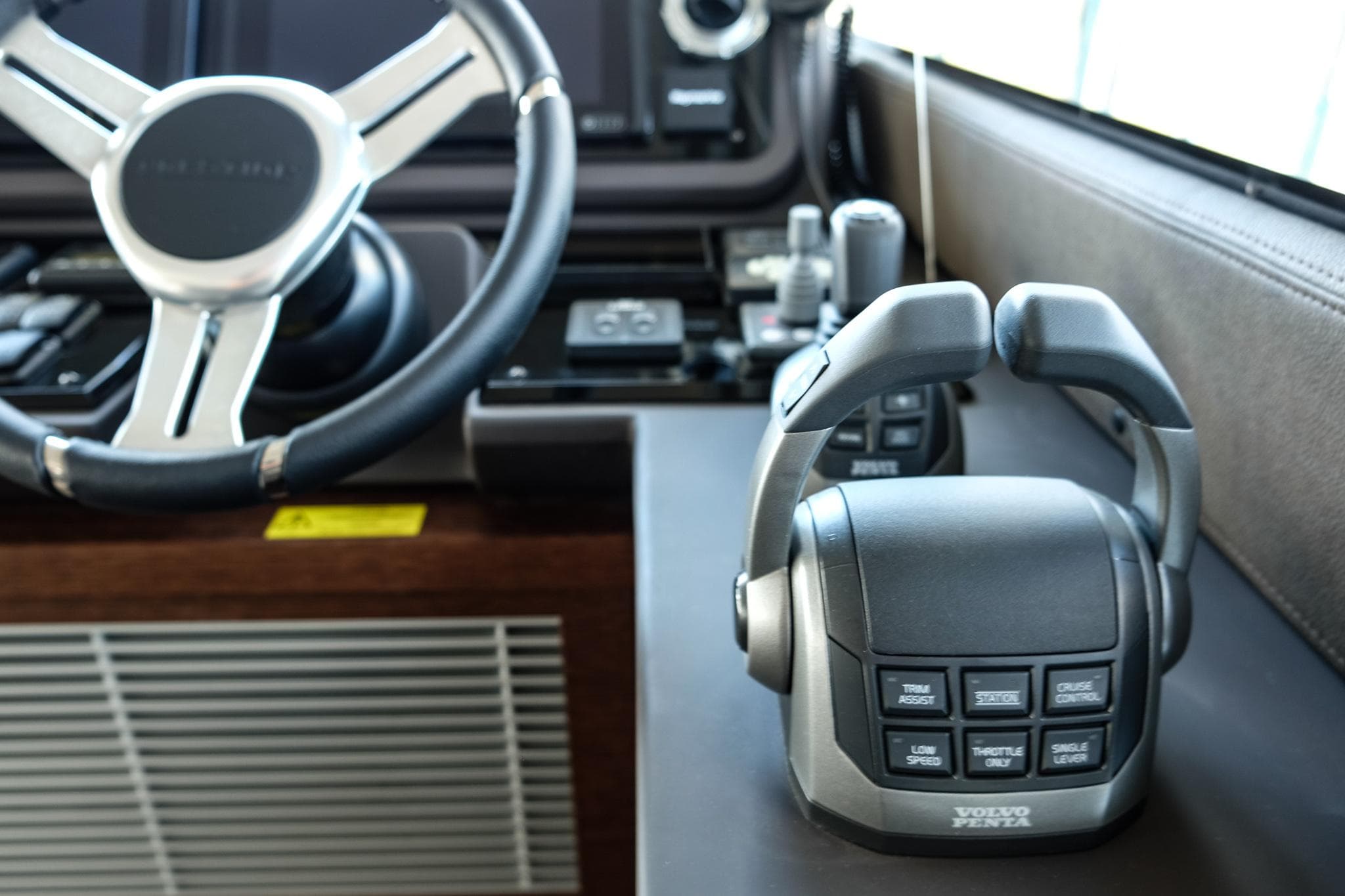 2024 Prestige 520 Flybridge helm with Volvo Penta controls and steering wheel.