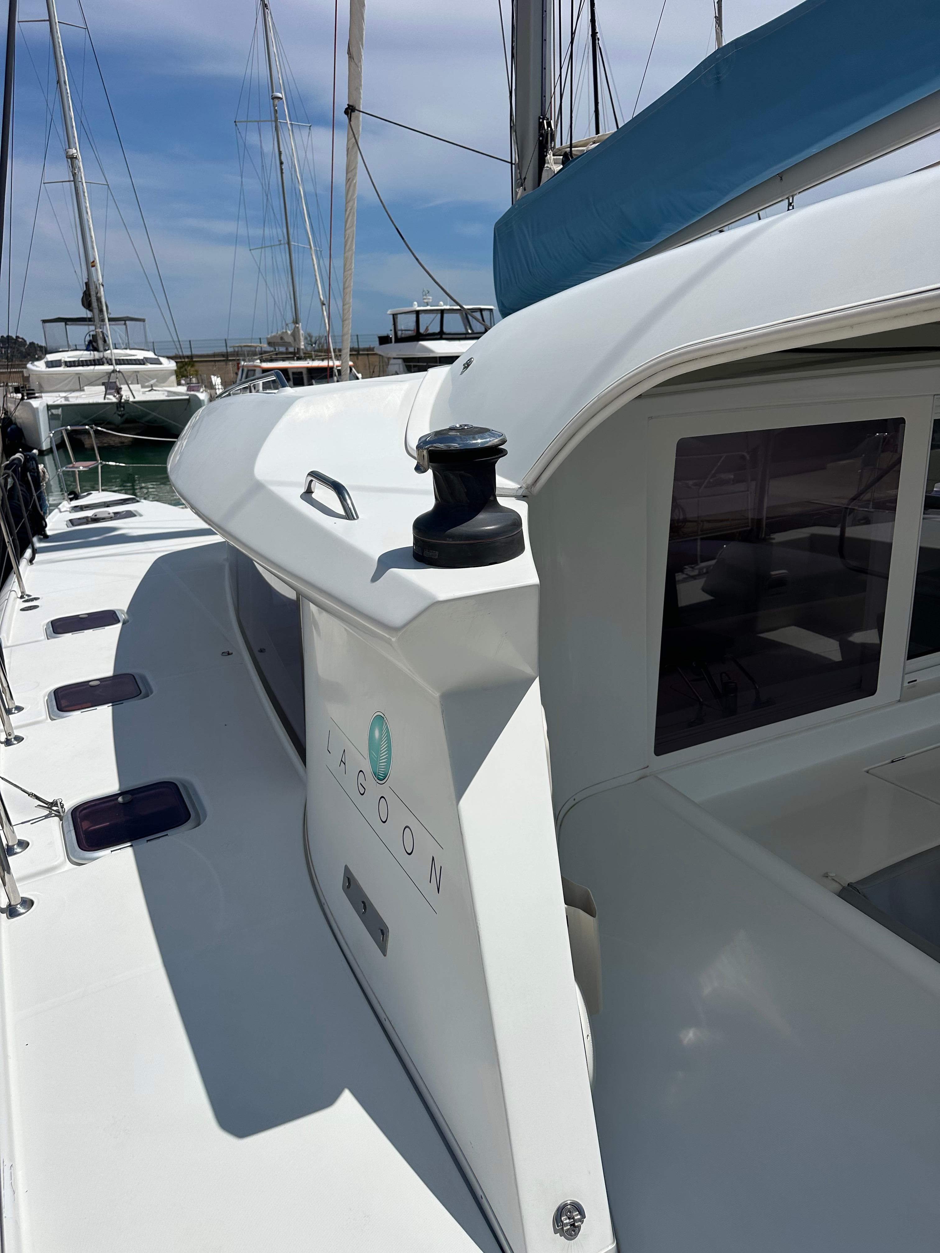 2007 Lagoon 421 catamaran deck view with winch and cabin windows.