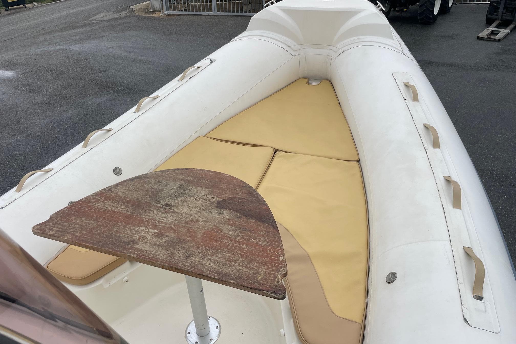 2008 Nuova Jolly King 670 boat interior with wooden table and beige seating.