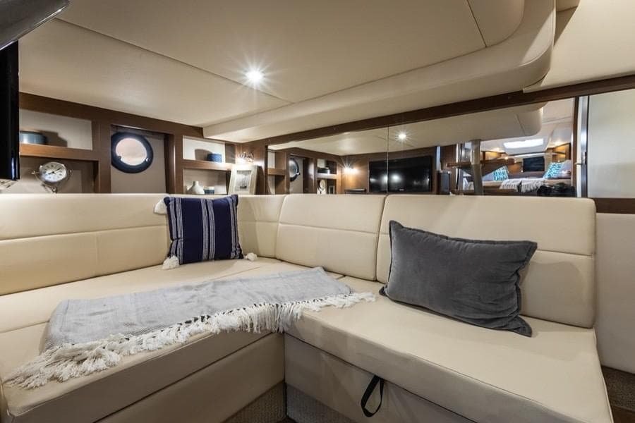 Manufacturer Provided Image: Interior of 2021 Sea Ray Sundancer 350 Coupe with beige seating and decorative pillows.