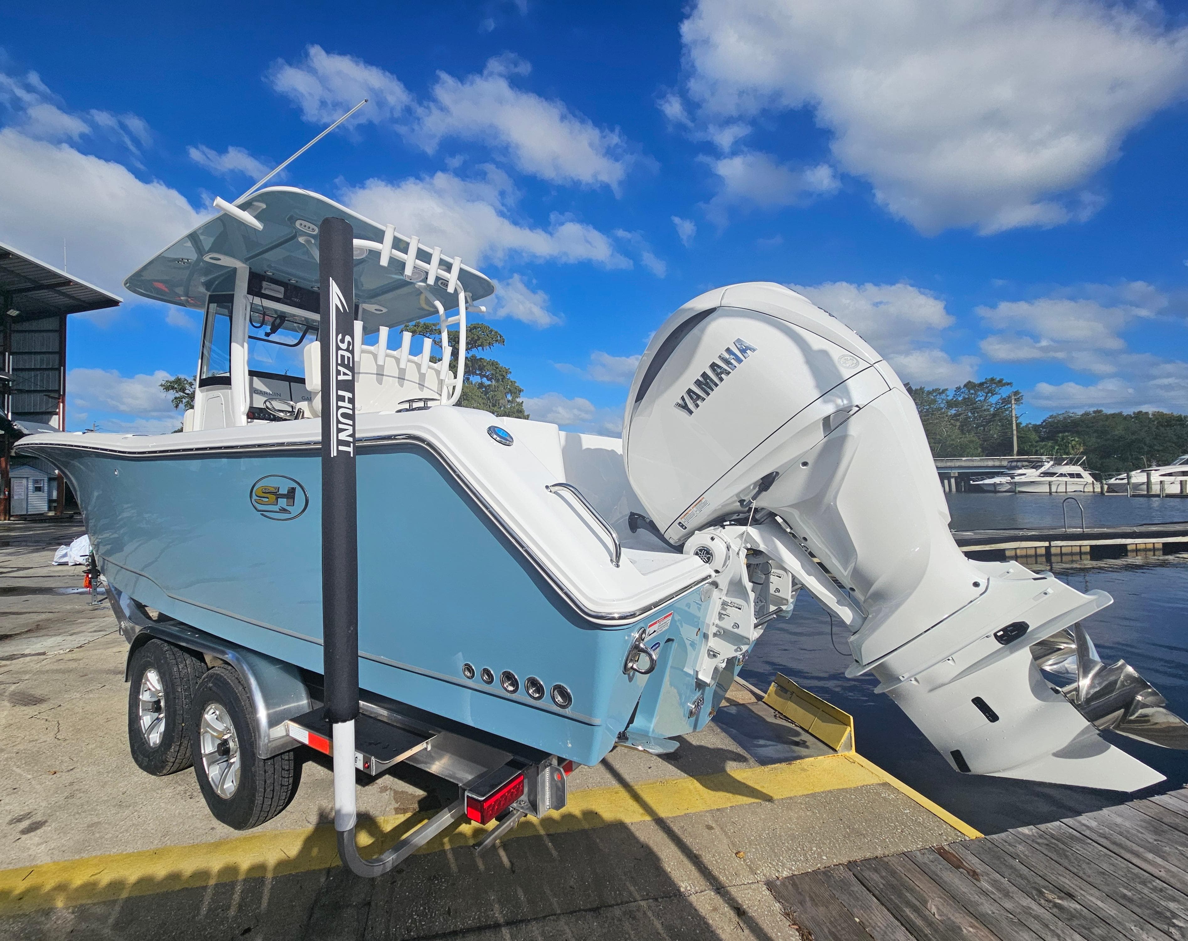 2025 Sea Hunt Gamefish 28 CB boat with Yamaha engine at dock.