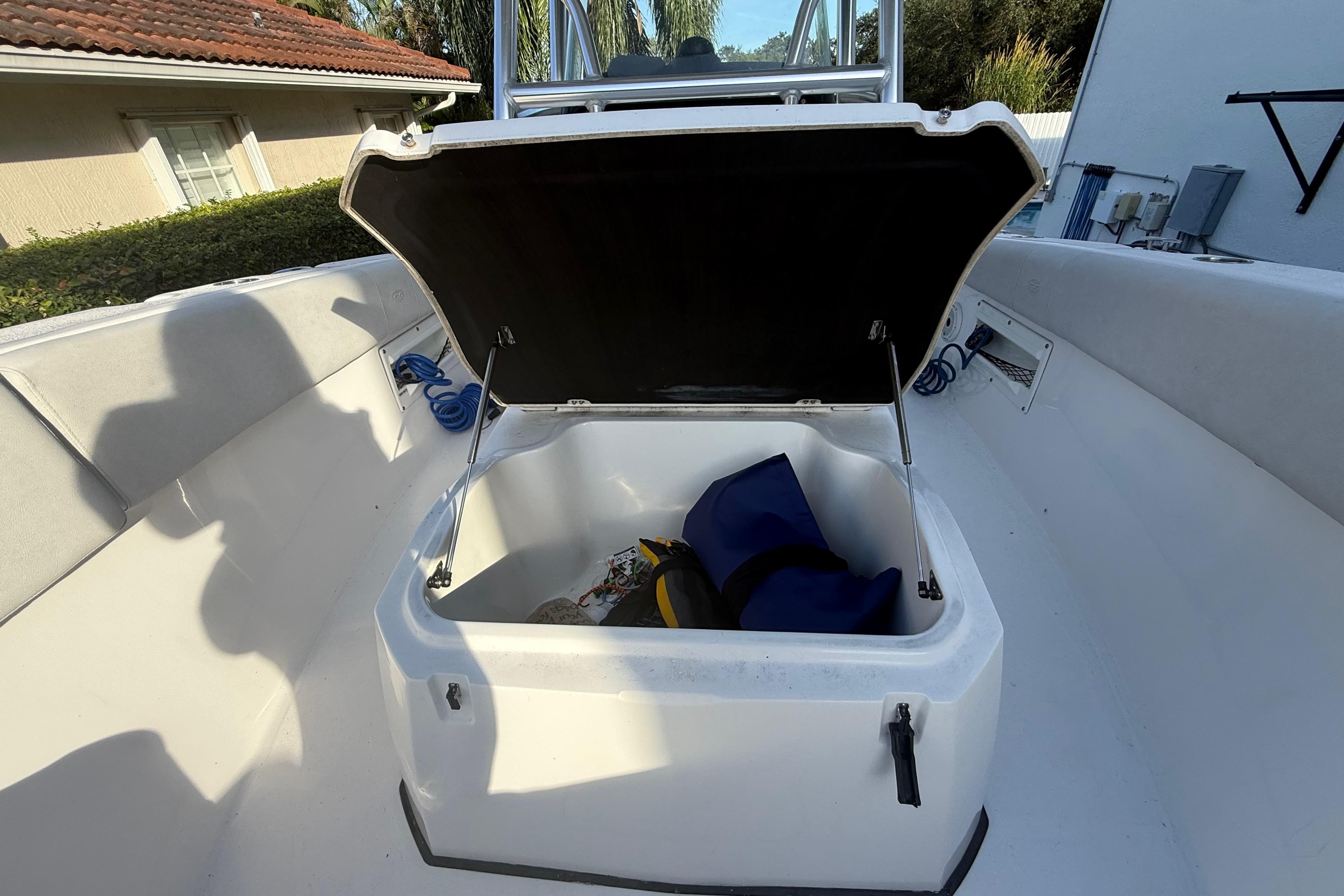 2021 Sea Fox 268 Commander boat storage compartment open with gear inside.