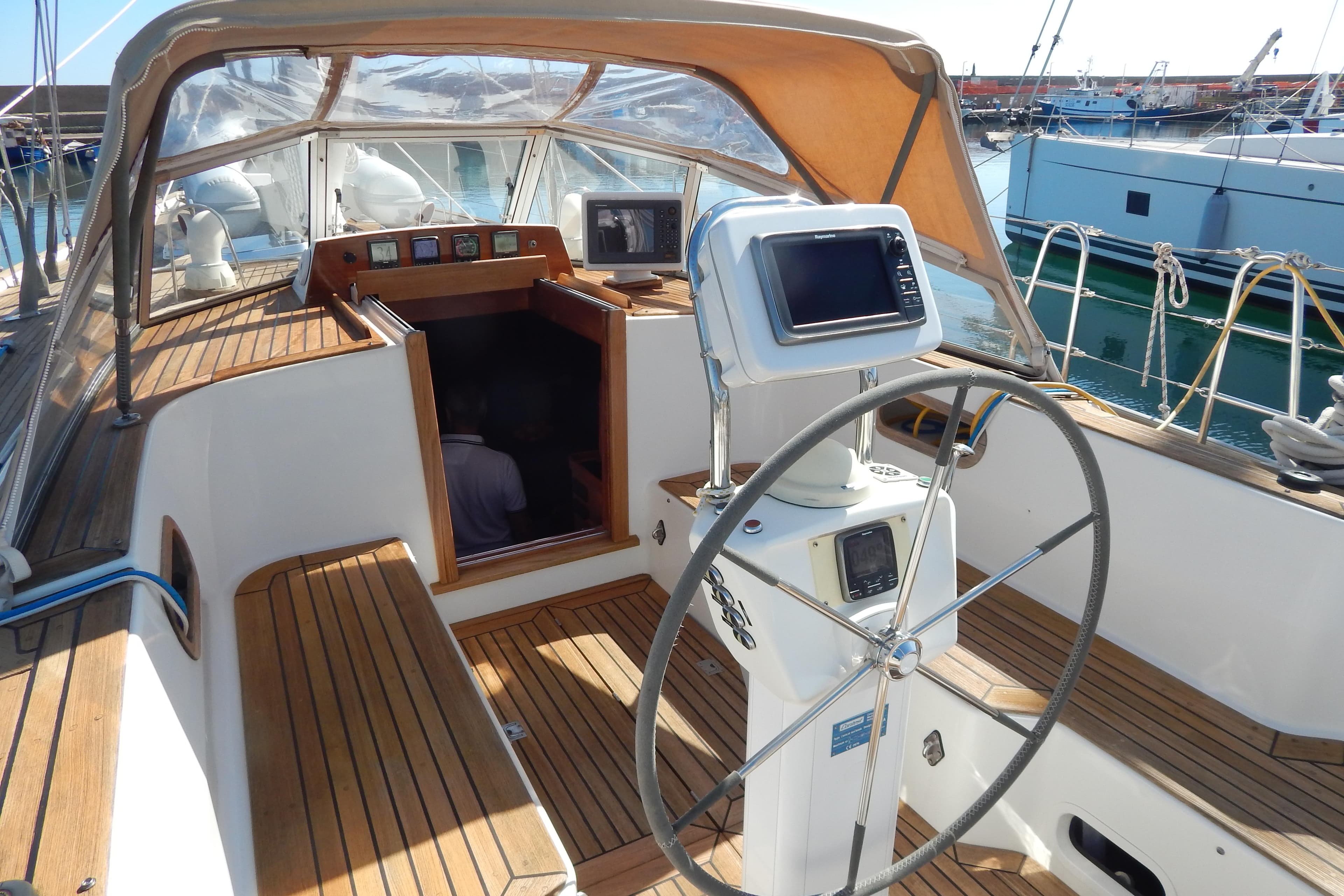 Cockpit of 2003 Contest 60 C yacht with steering wheel and navigation equipment.