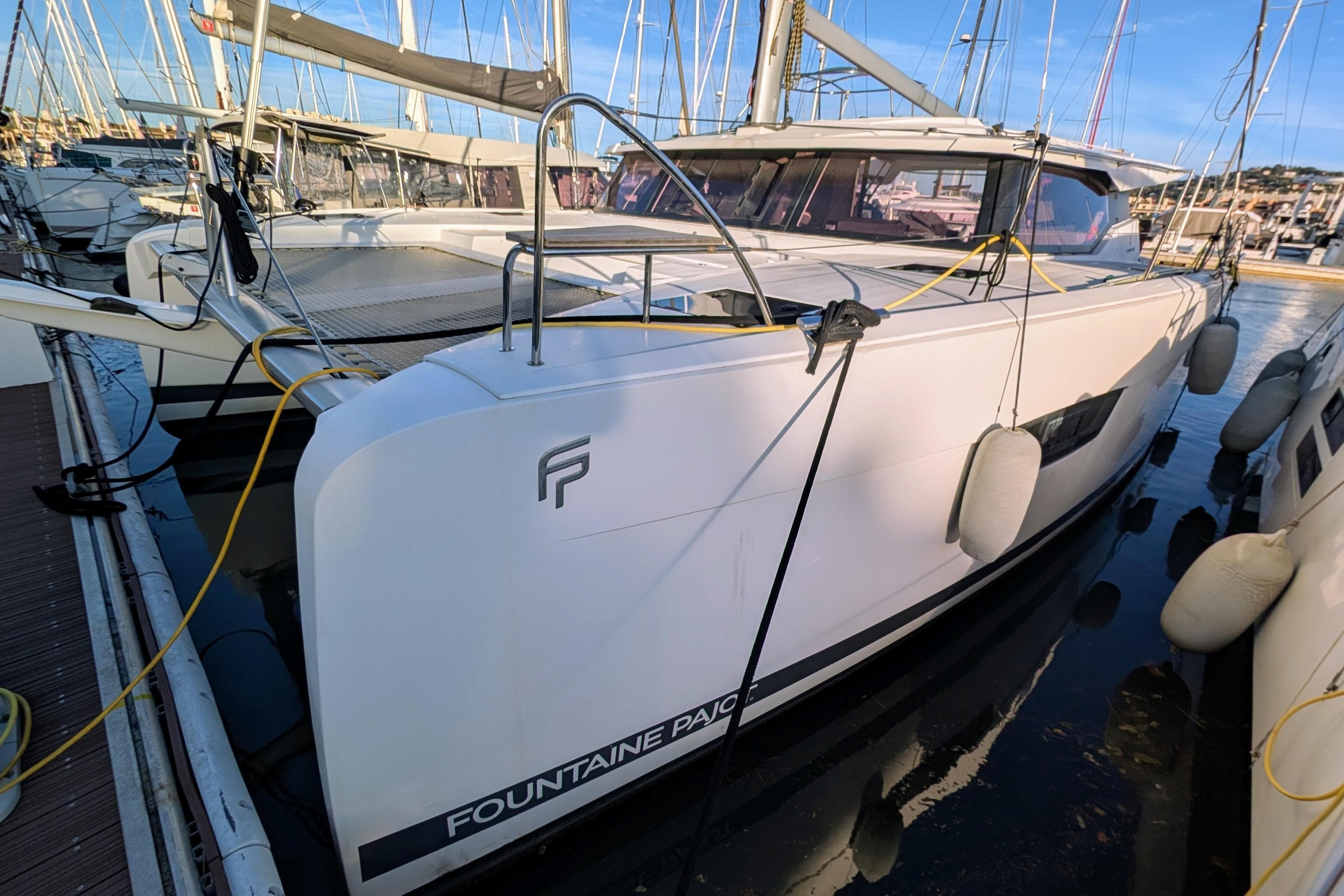 2020 Fountaine Pajot Astrea 42 Catamaran docked in marina, side view.