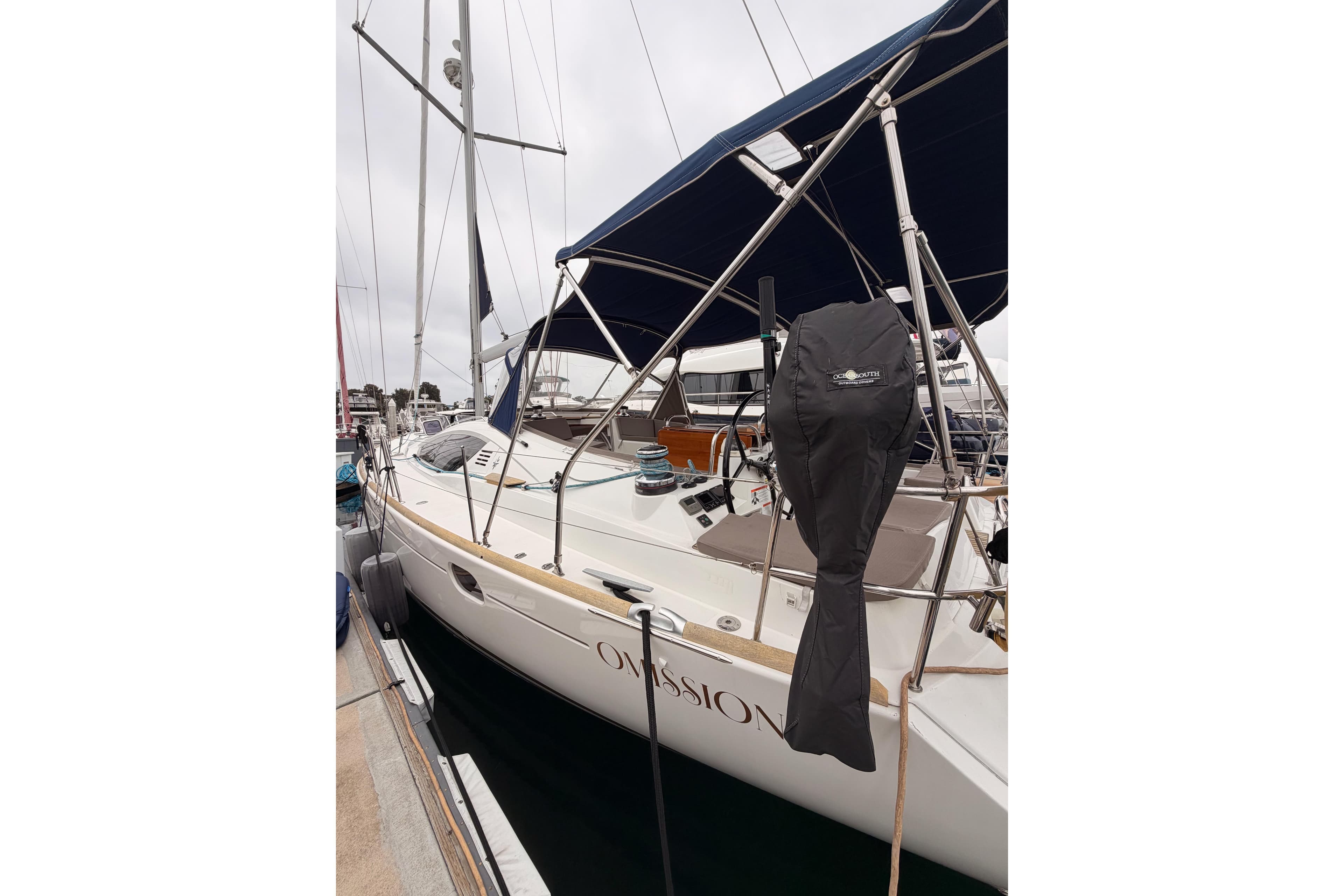 2014 Jeanneau Sun Odyssey 50 DS sailboat docked, featuring sleek design and covered equipment.