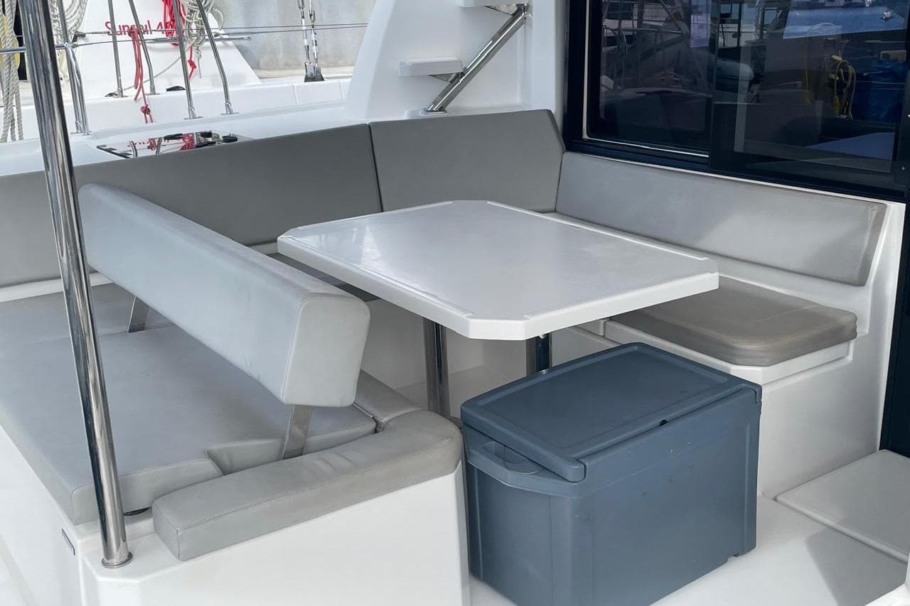 Modern seating area on 2022 Leopard 42 yacht with table and cushioned benches.