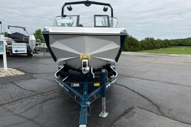 2022 Nautique Super Air Nautique G21 boat on trailer, parked outdoors.