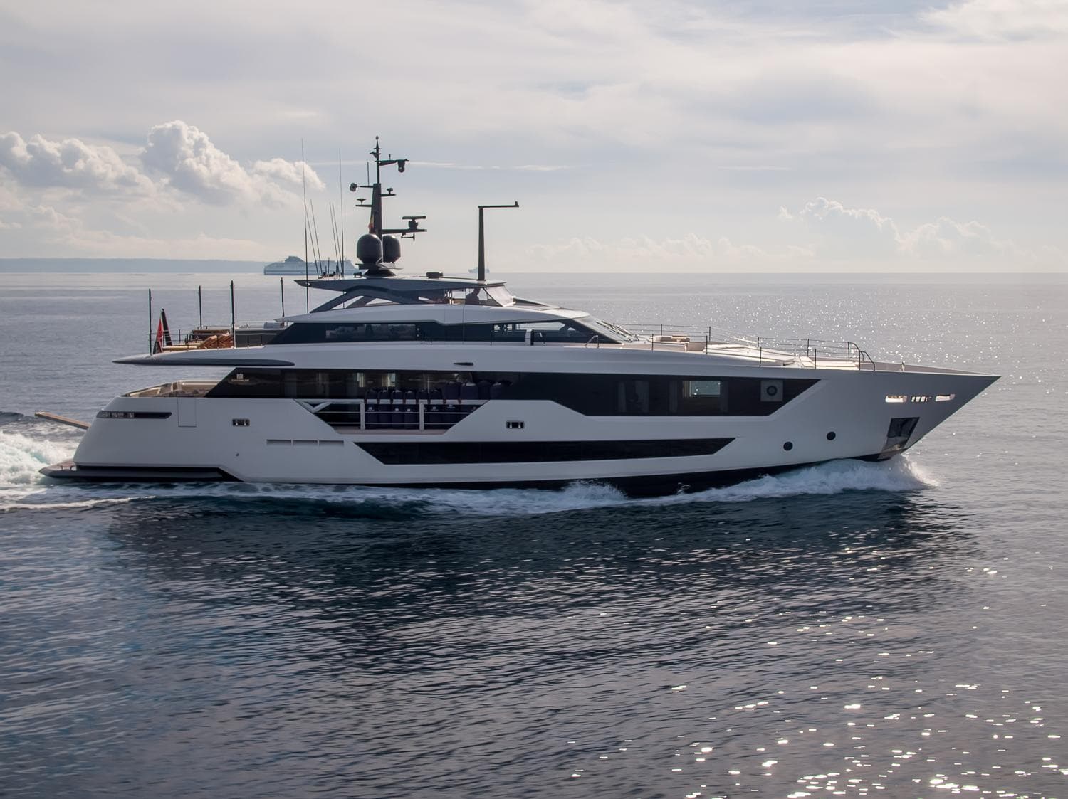 Luxury yacht Custom Line 106, 2019 model, cruising on open sea under clear sky.