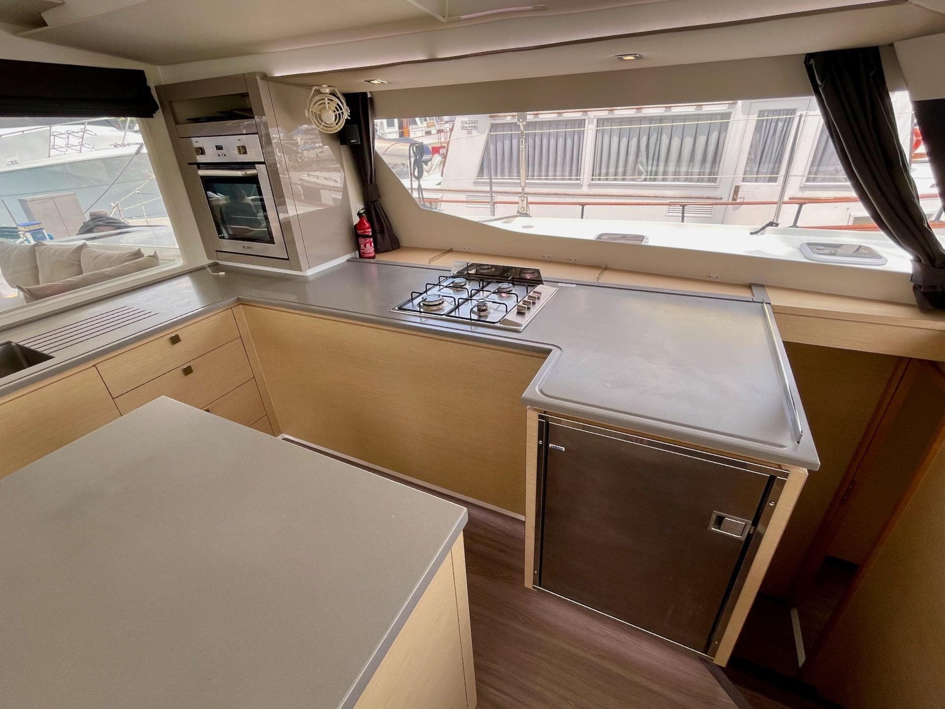 Modern kitchen interior of 2017 Fountaine Pajot SABA 50 catamaran with stove and oven.