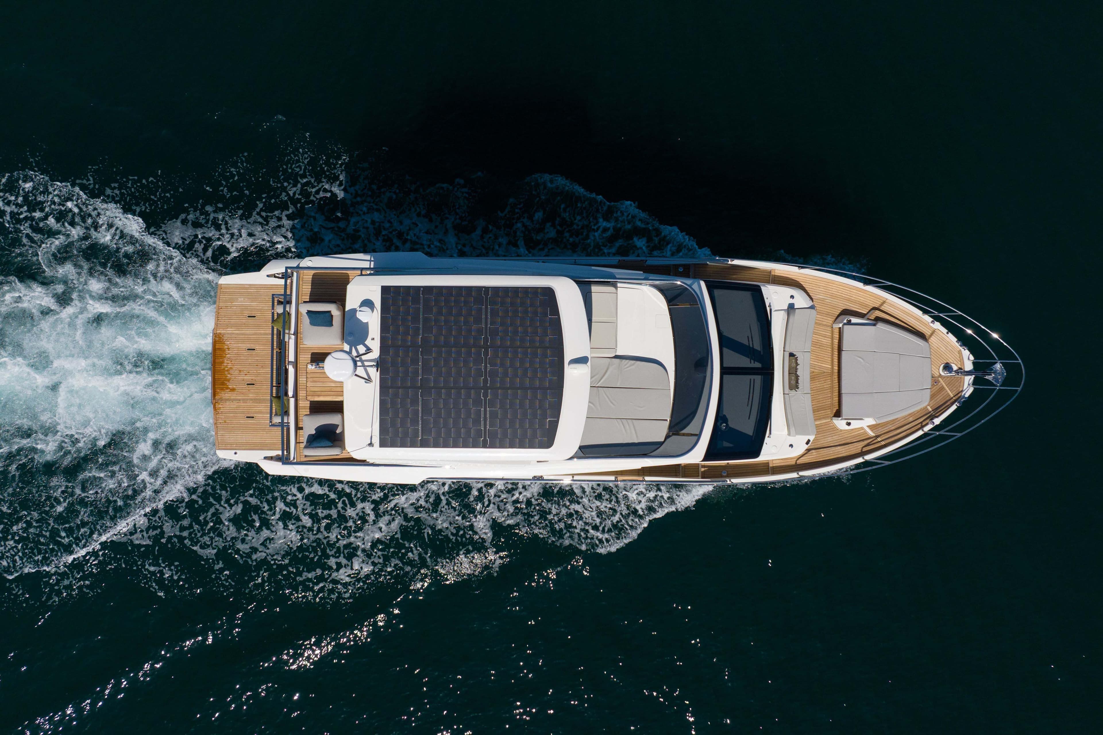 Aerial view of 2026 Absolute 52 Fly yacht cruising on open water.