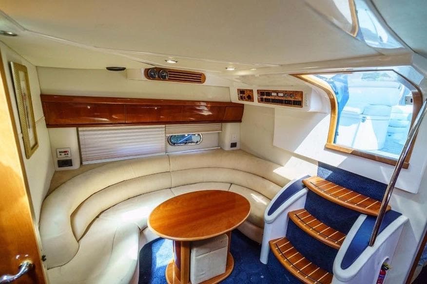 Interior of 2001 Sealine S41 Sports Cruiser with elegant seating and wooden accents.