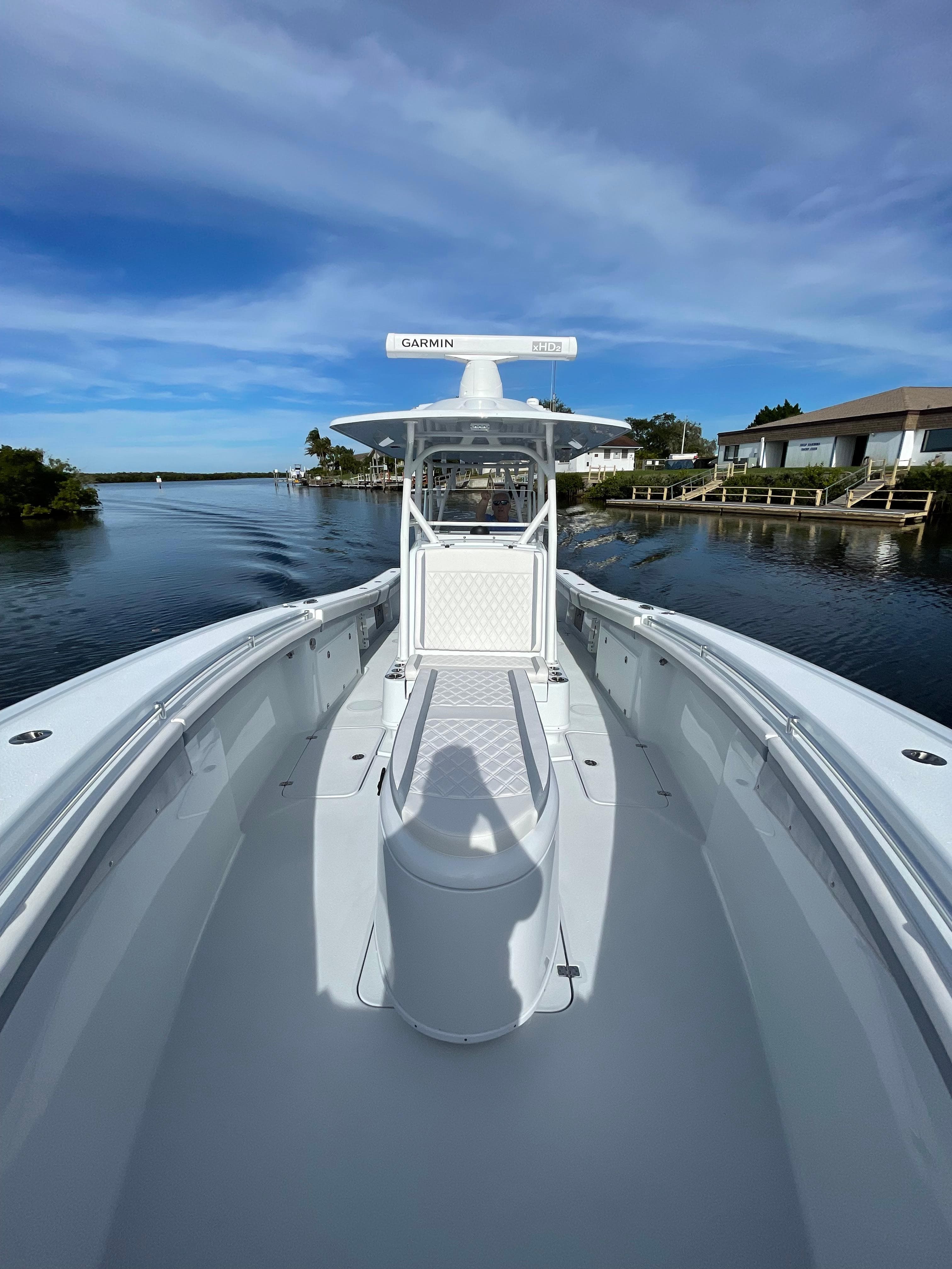 2022 Yellowfin 34 boat on a calm waterway under a clear blue sky.
