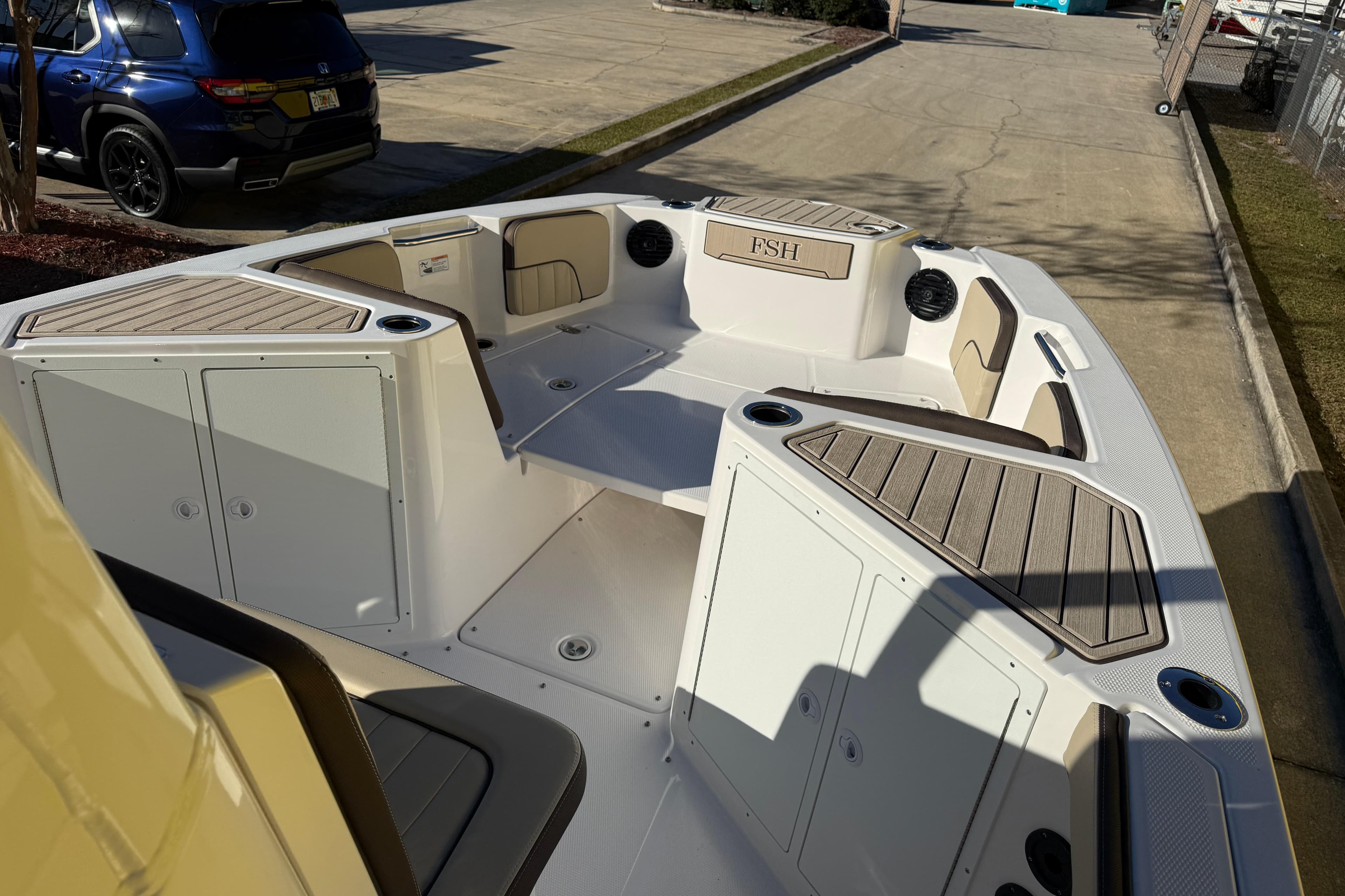 2026 Yamaha Boats 222 FSH Sport E interior with seating and storage compartments.