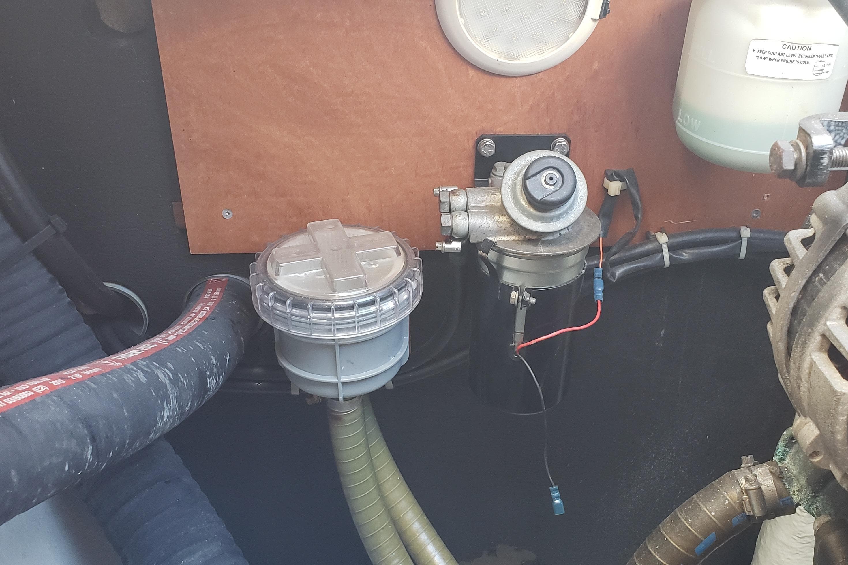 Engine compartment of a 2016 Lagoon 400 S2 with visible hoses and components.