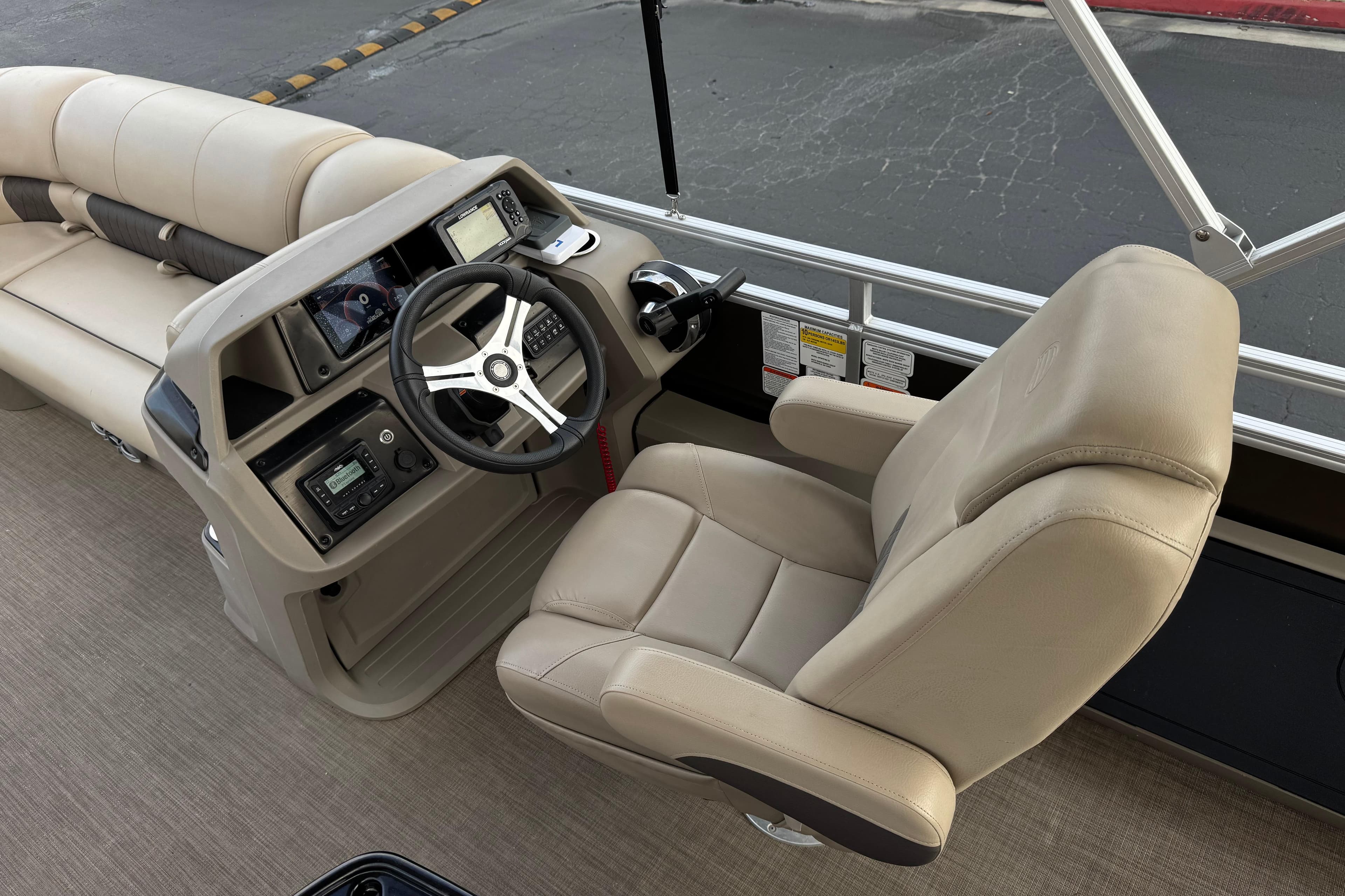 2024 Sun Tracker SportFish 22 DLX boat interior with steering console and comfortable seating.