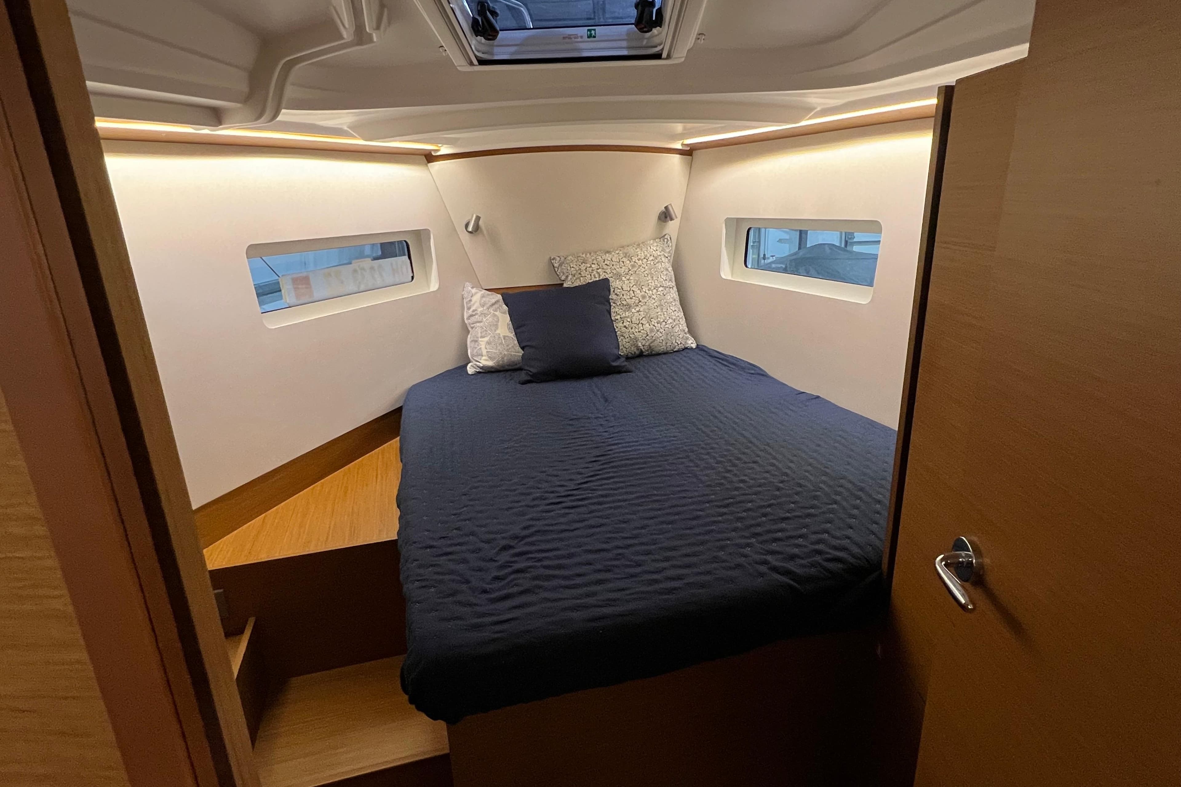 2023 Jeanneau Sun Odyssey 380 cabin interior with cozy bed and modern design.