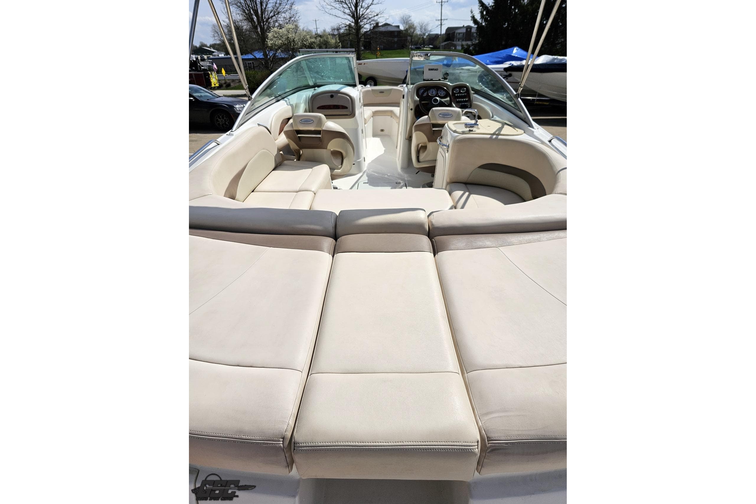 2007 Chaparral 256 SSi boat interior with beige seating and modern dashboard.