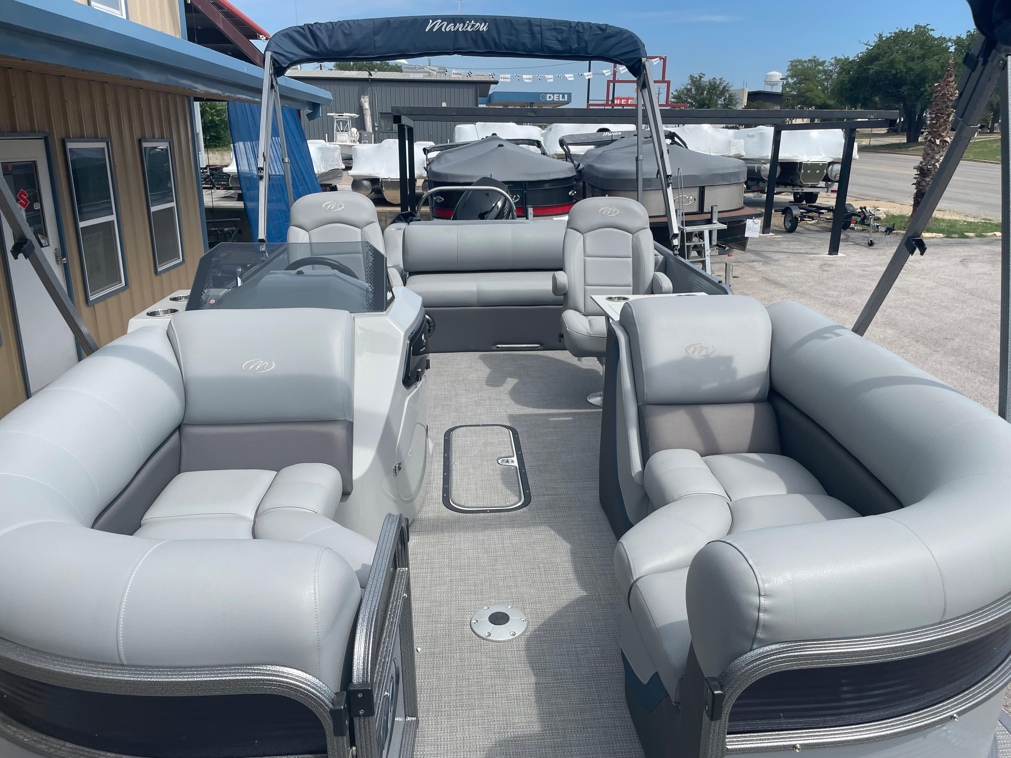 2022 Manitou Oasis 23 SL SHP373 pontoon boat with spacious seating and canopy.